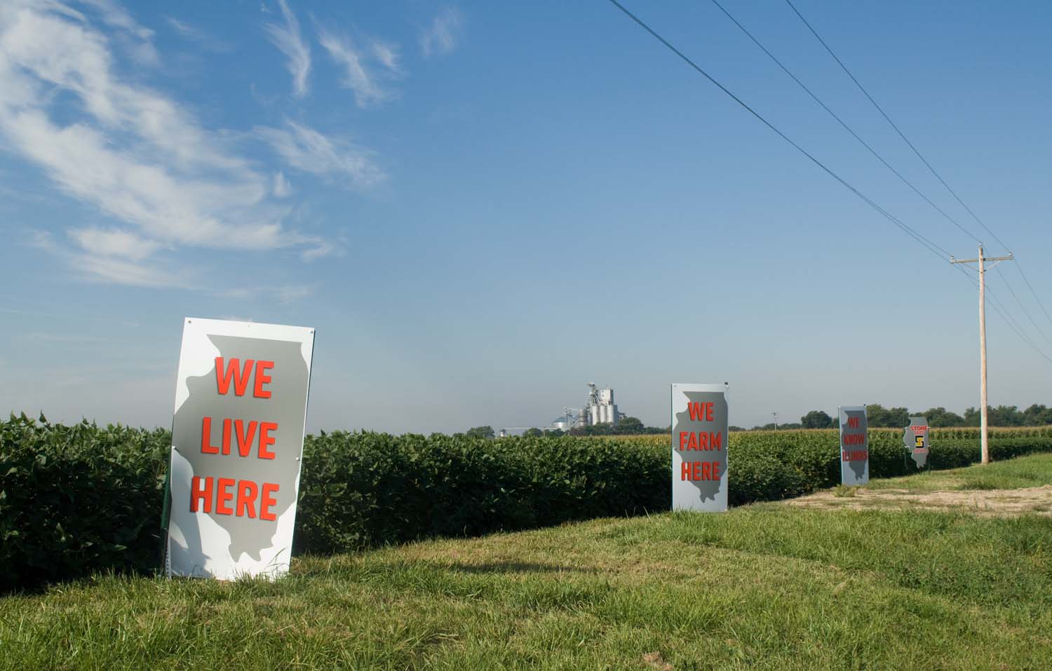  Stone Seed Group signs that reads We Live Here, We Farm Here, We Know IL.  September, 2013 