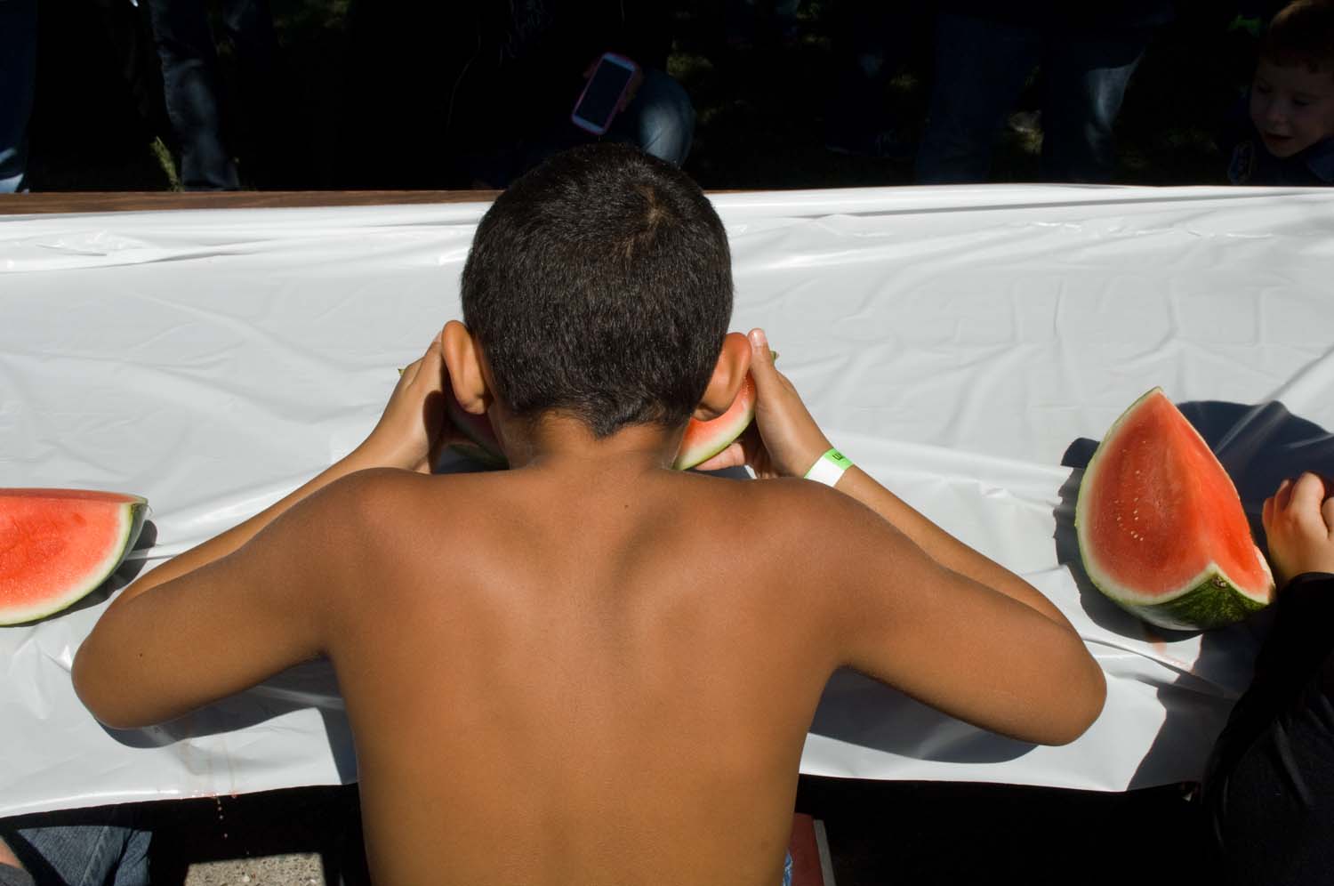  Young boy at a watermelon eating contest held at the Bowen festival. Bowen, IL. September, 2014. 