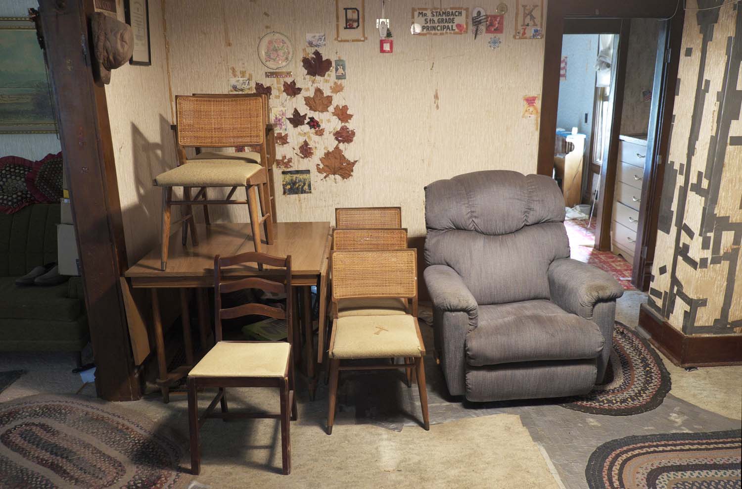  Living room view of a house up for auction. There is duck tape on the wall and floor. Bowen, IL. July, 2016 