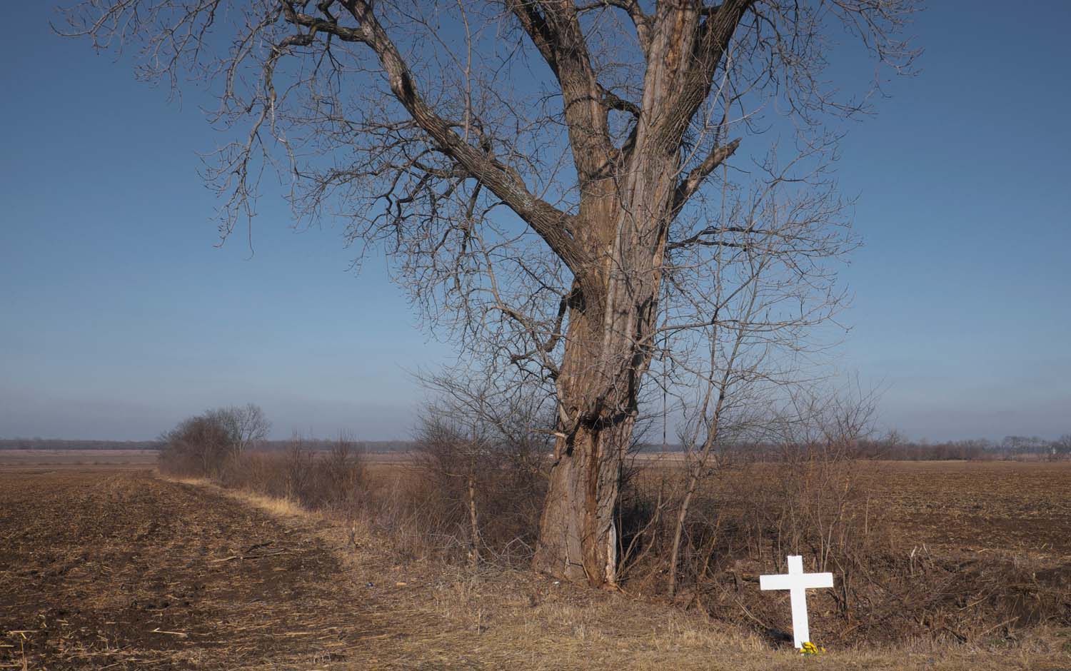 White cross by the side of the road marking a fatal accident. Schuylar County, IL January, 2017 