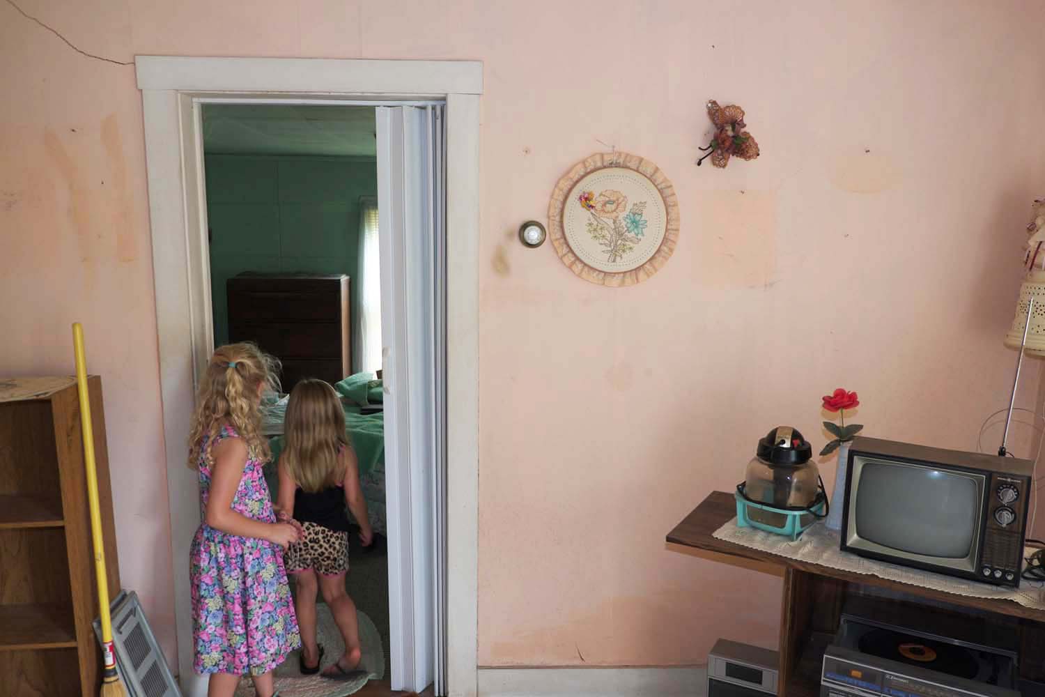  Two girls exploring the inside of a house up for auction. Bowen, IL. October, 2016 