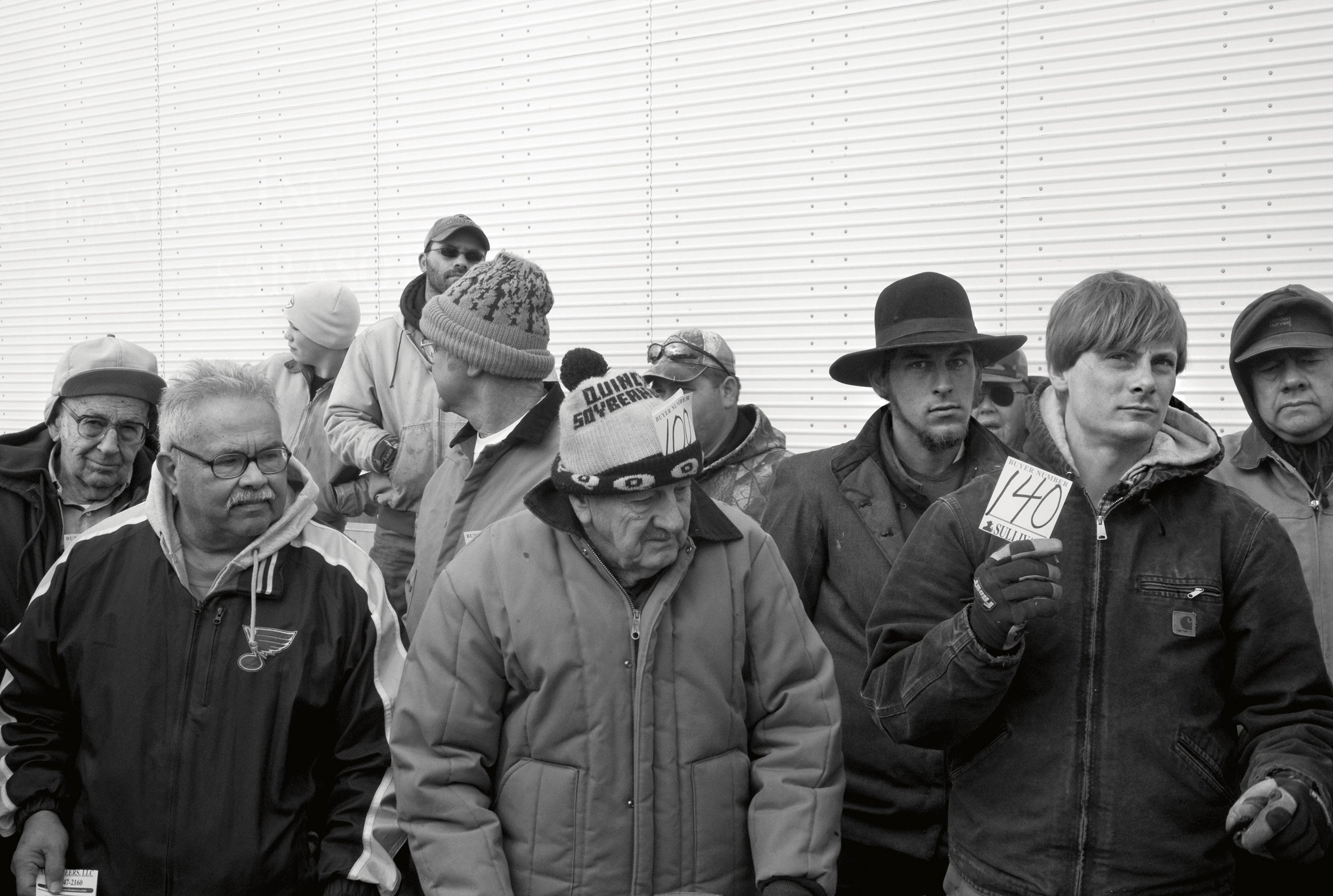  Men standing outside in the winter at an auction in Lorraine, IL. Feb. 2009 