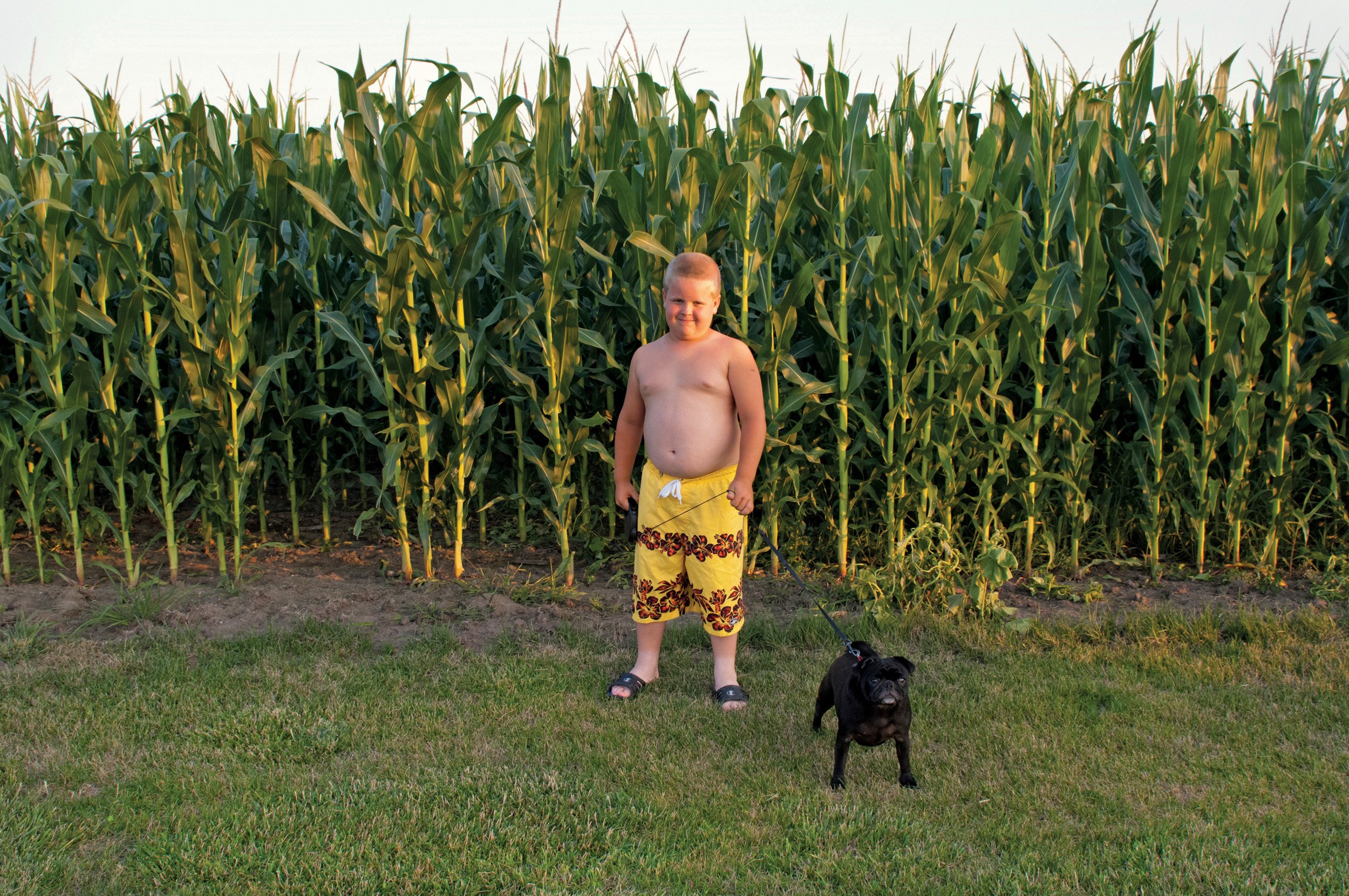  Unidentified boy with dog, corn in the background. Hanncock County, IL. July, 2007 