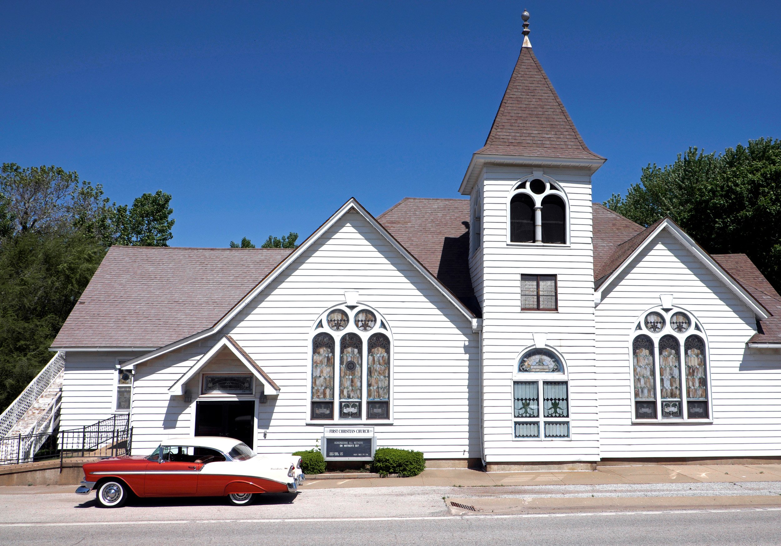  Red and white ‘56 Chevy car parked in front of First Christian Church. Dallas City, IL May, 2016 