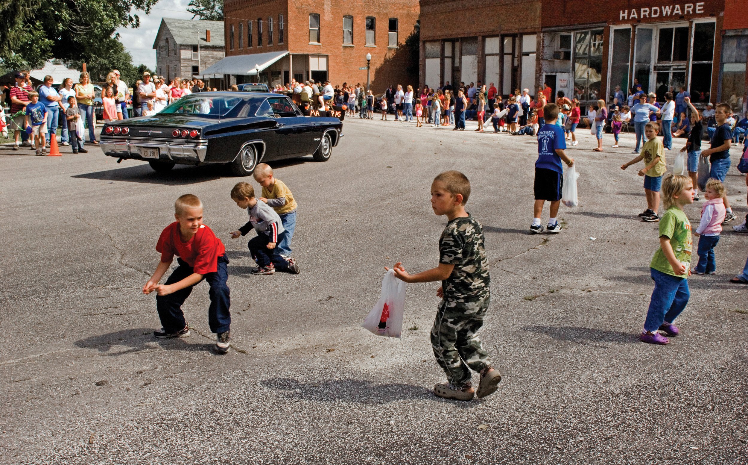  Plymouth Old Settlers festival parade. Kids are picking up candy during the parade. Plymouth, IL. August, 2009 