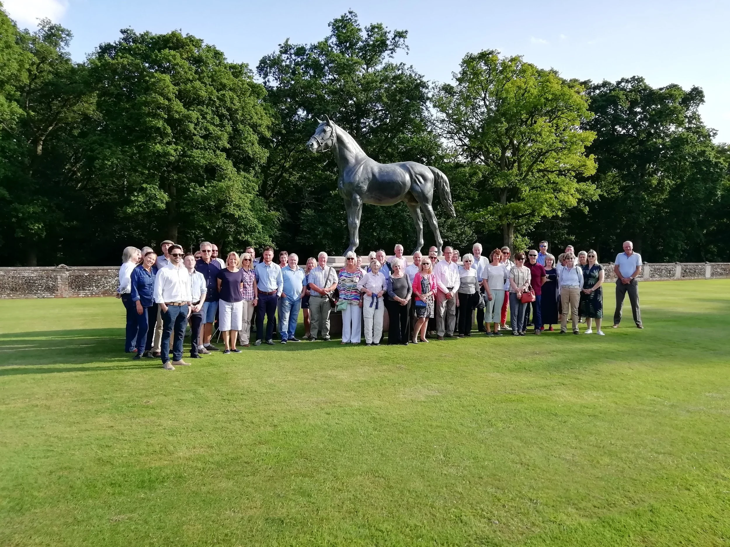 The stud visitors standing in front of Persimmon, winner of the Derby in 1896, owned by the Prince of Wales.