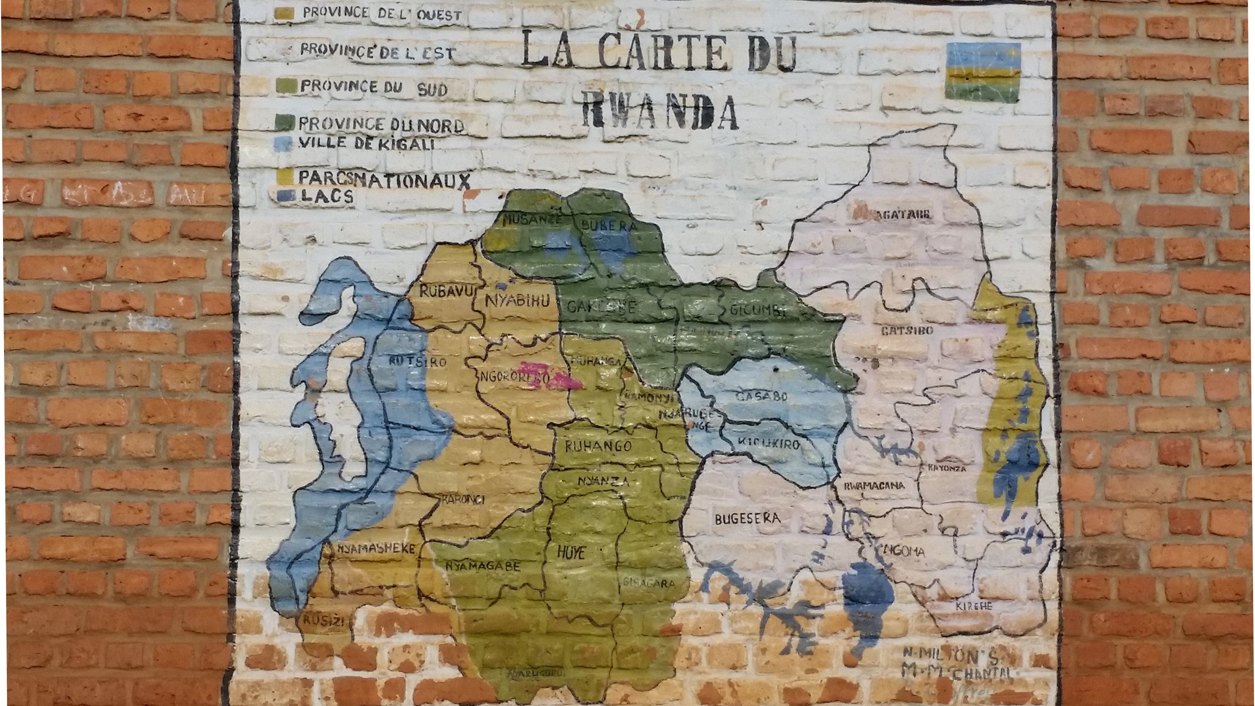 Creative use of the exterior walls of a classroom building at a school near Kayonza.