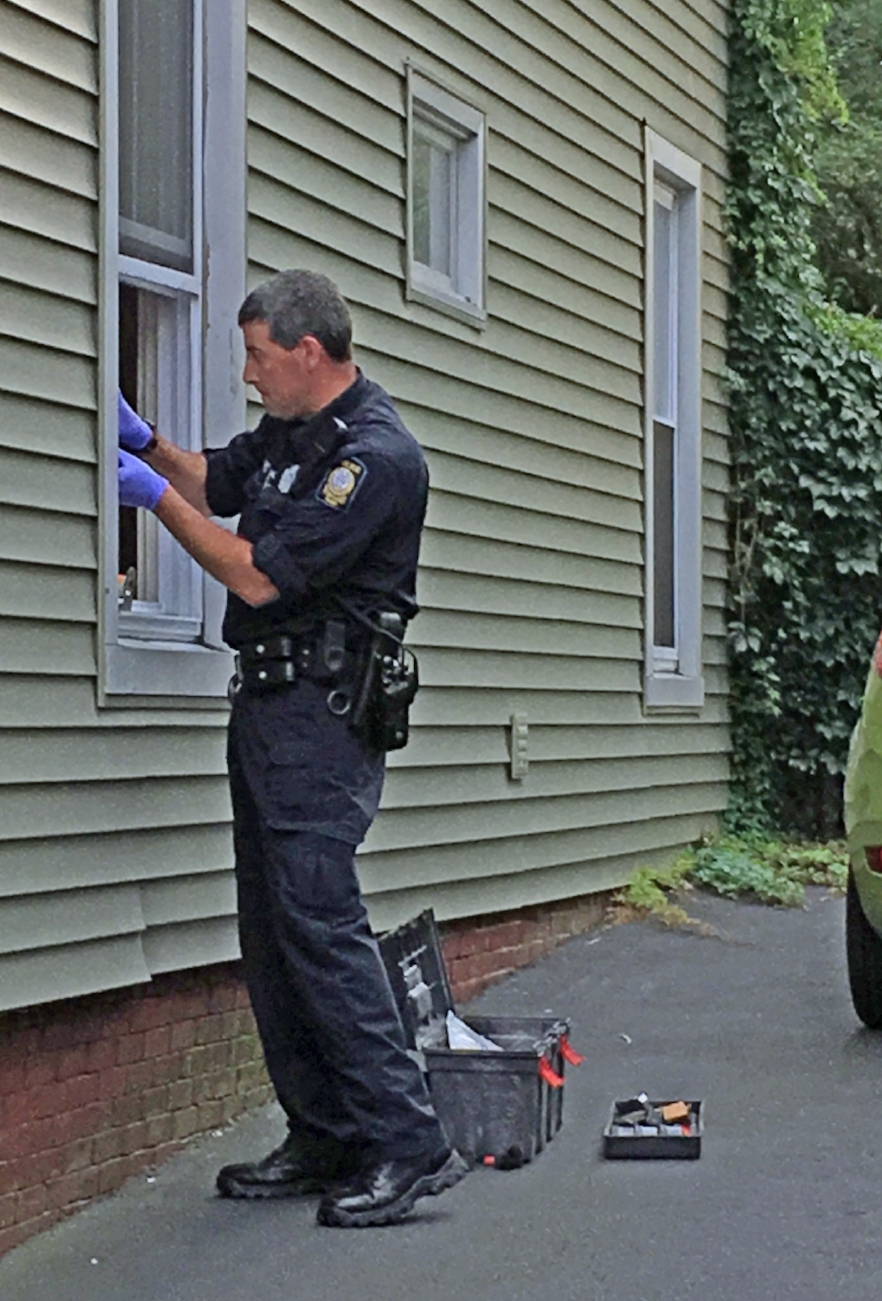 Portland Police officer V. Cote removing fingerprints from robbery scene at 94 Beckett Street Thursday afternoon. Photo: The Munjoy Hill Observer