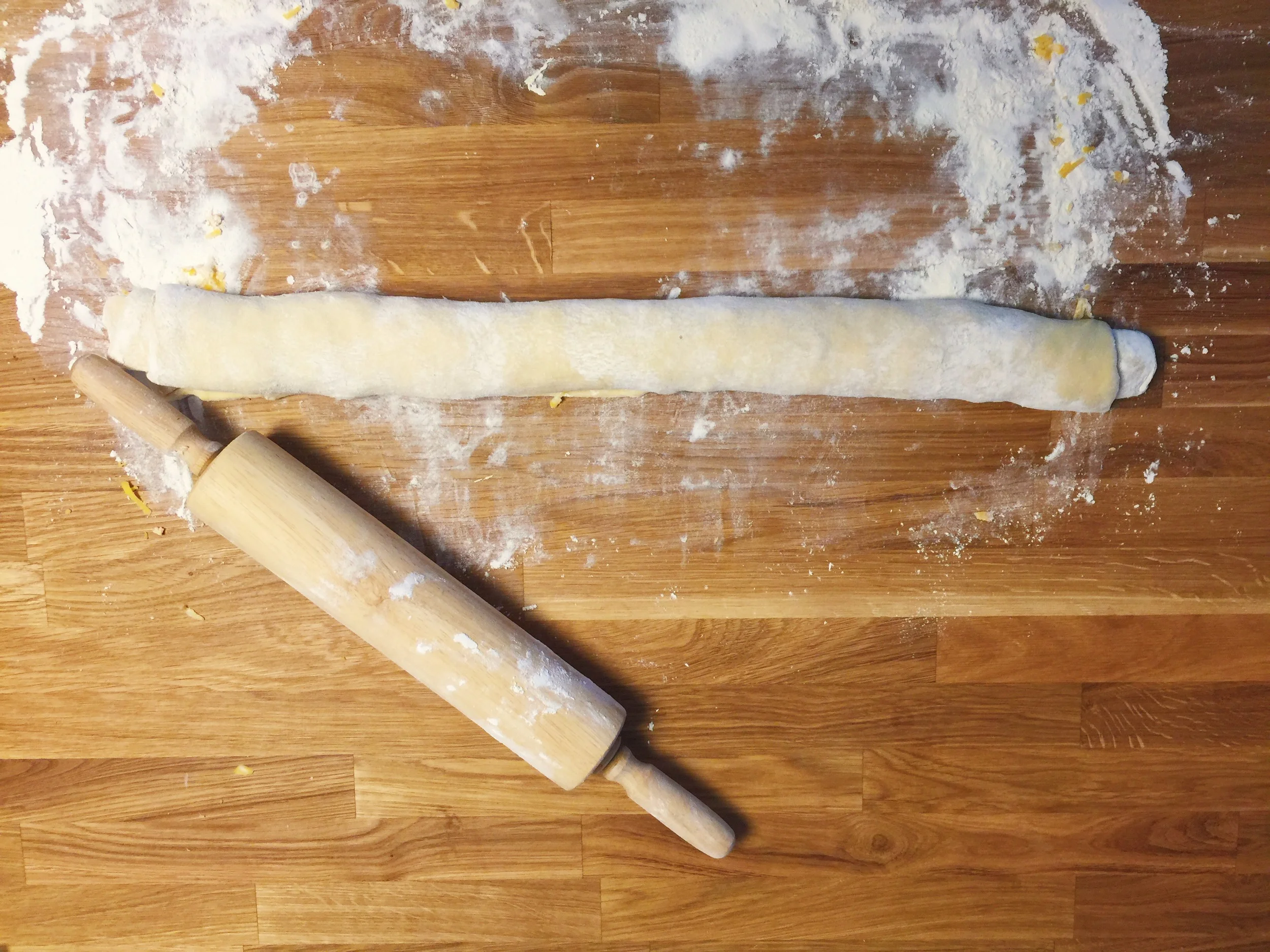 Once the dough is rolled up like a jelly-roll, take a very sharp knife and slice it straight through the middle. It will feel odd, and potentially messy, but that means you're doing it right!