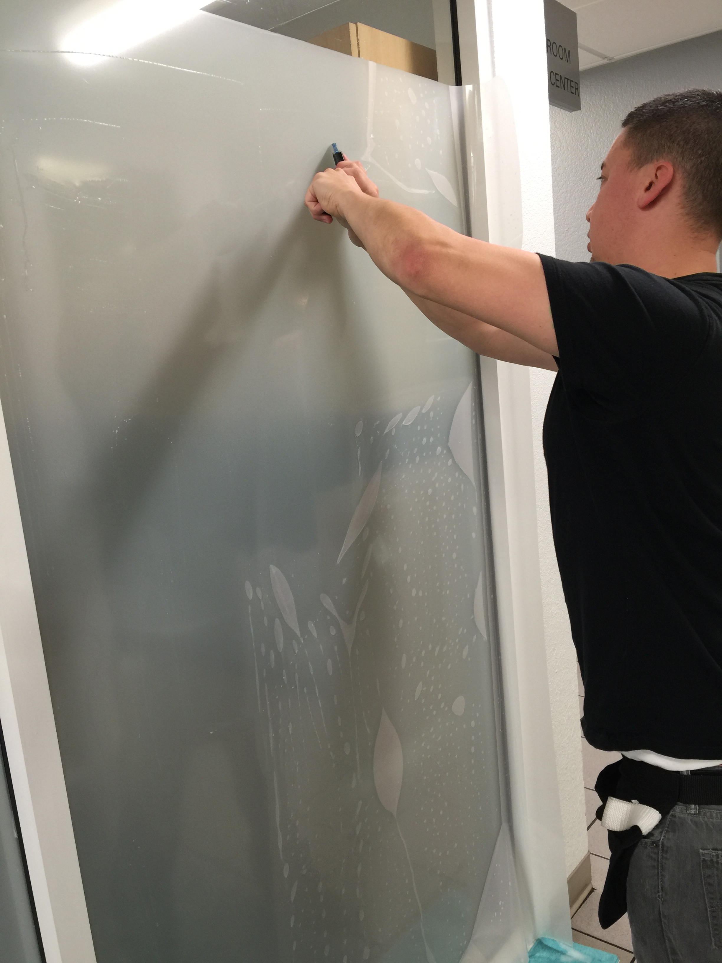 Aaron installing white frost privacy film