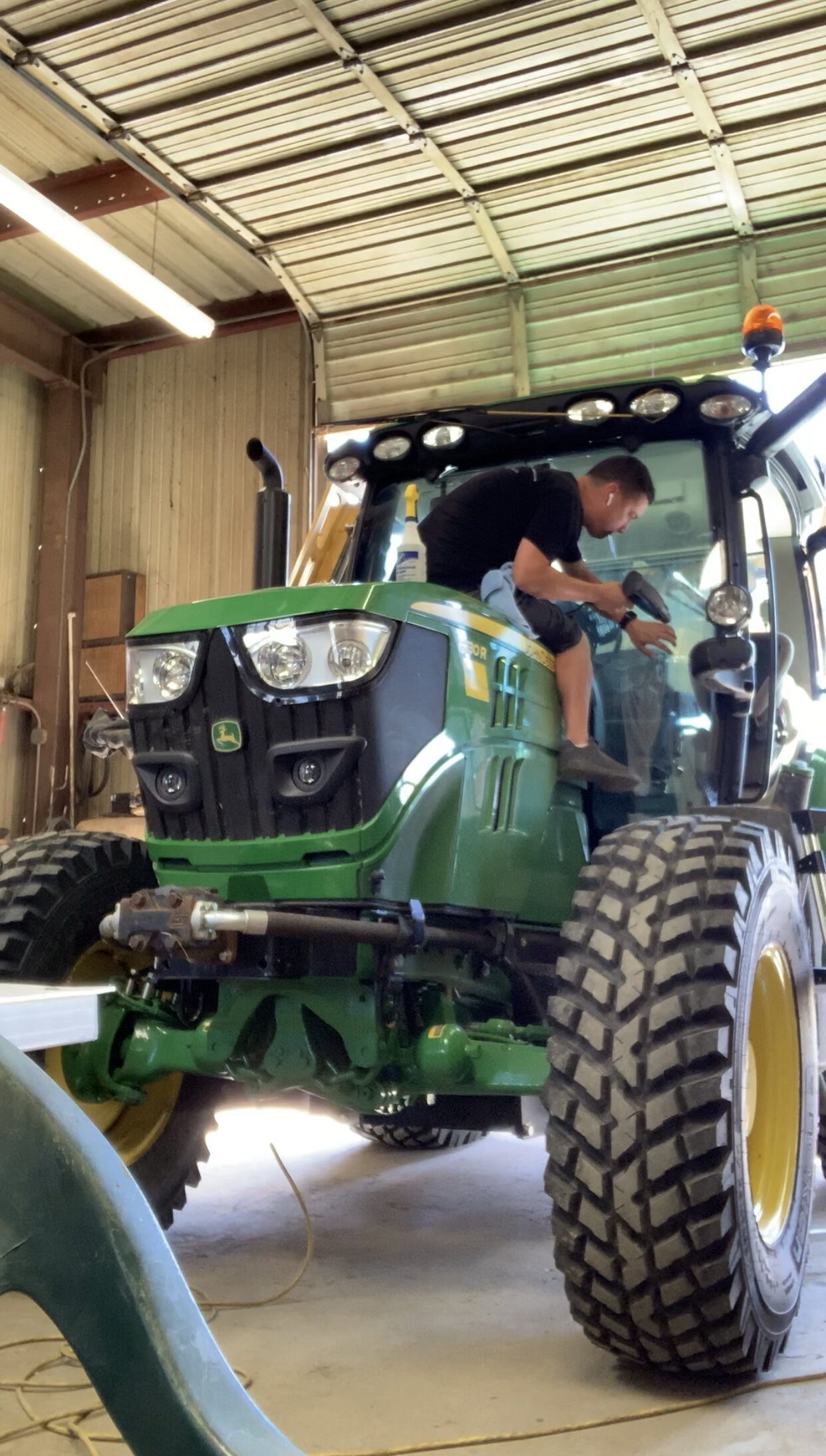 Aaron heatshrinking a tractor windshield