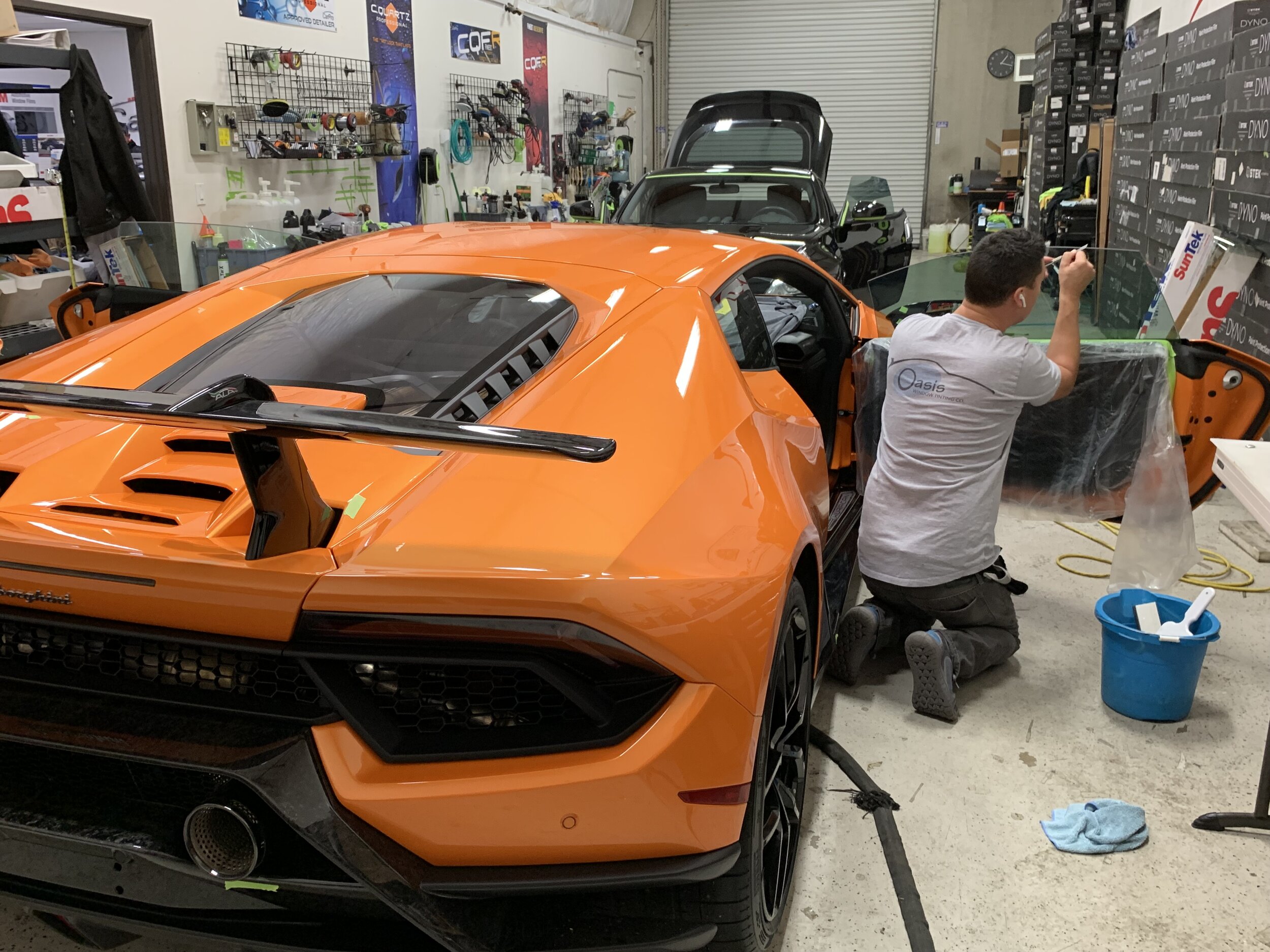 Aaron installing tint at a local detail shop