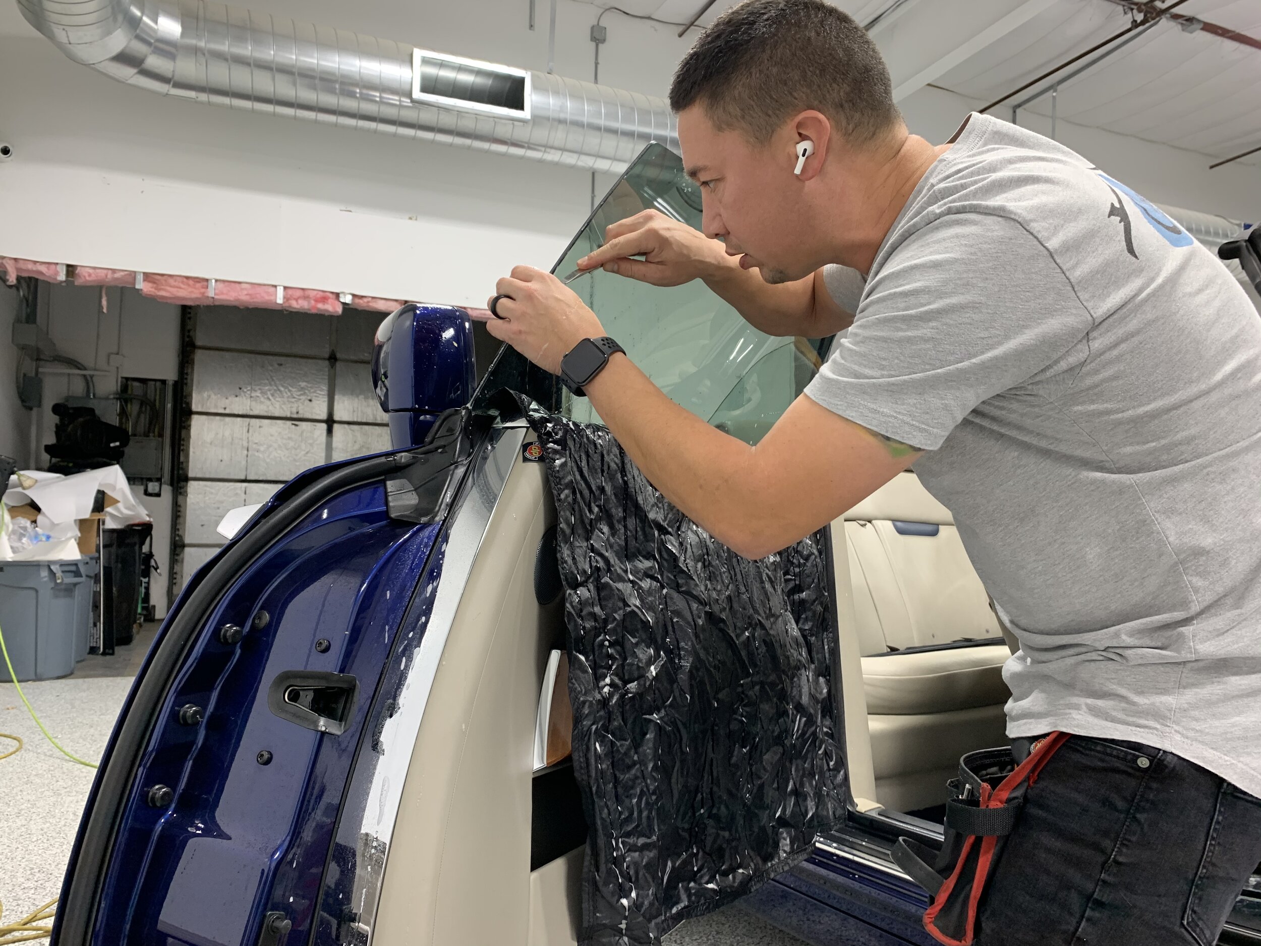 Aaron installing tint on this Rolls Royce Convertible