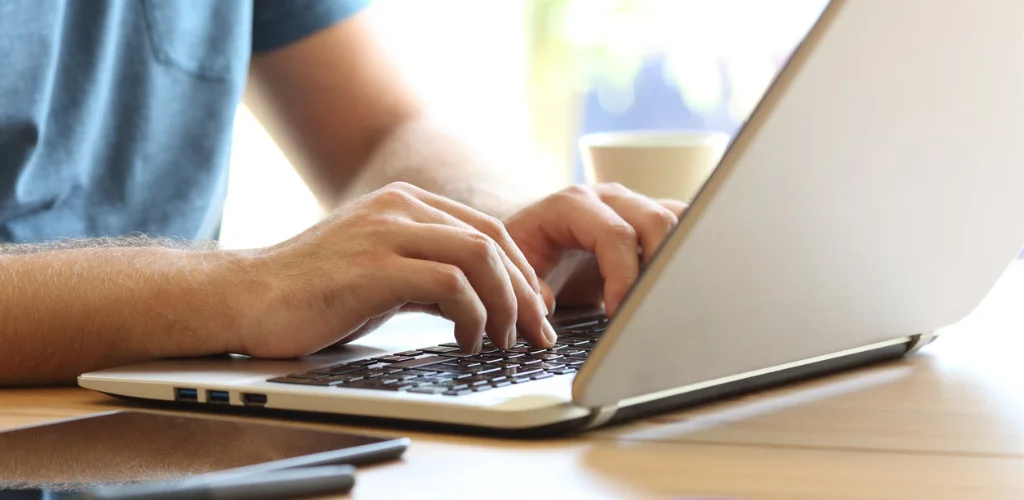 man-hands-typing-on-a-laptop-keyboard-on-a-desk-picture-id865728066.jpg
