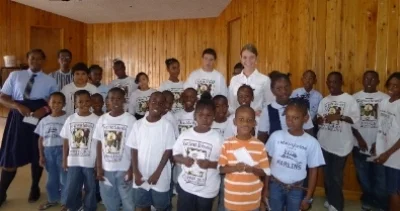 Ayla with school children after her presentation in the Bahamas.