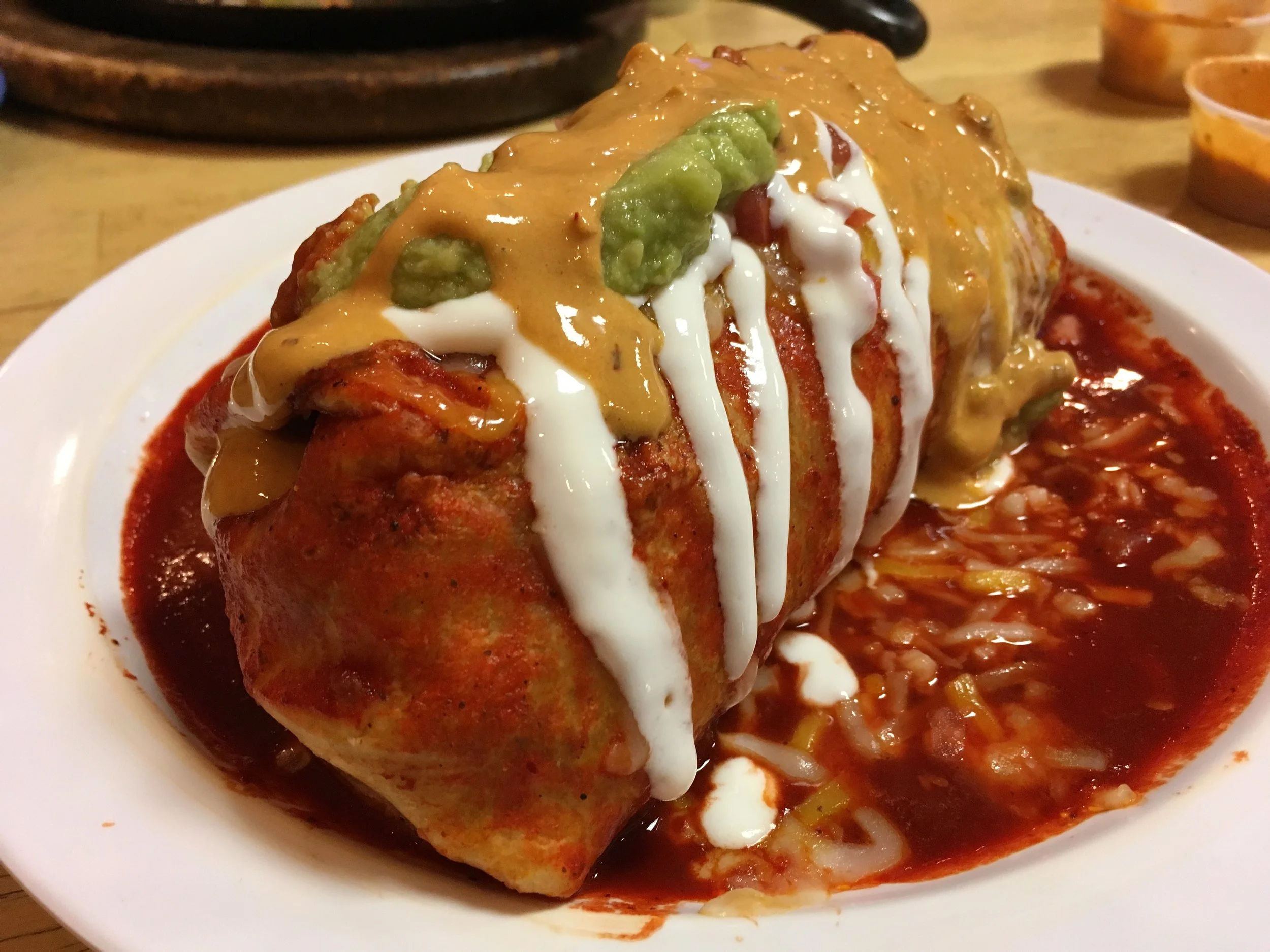 Pastor burrito smothered rojo from El Chubasco