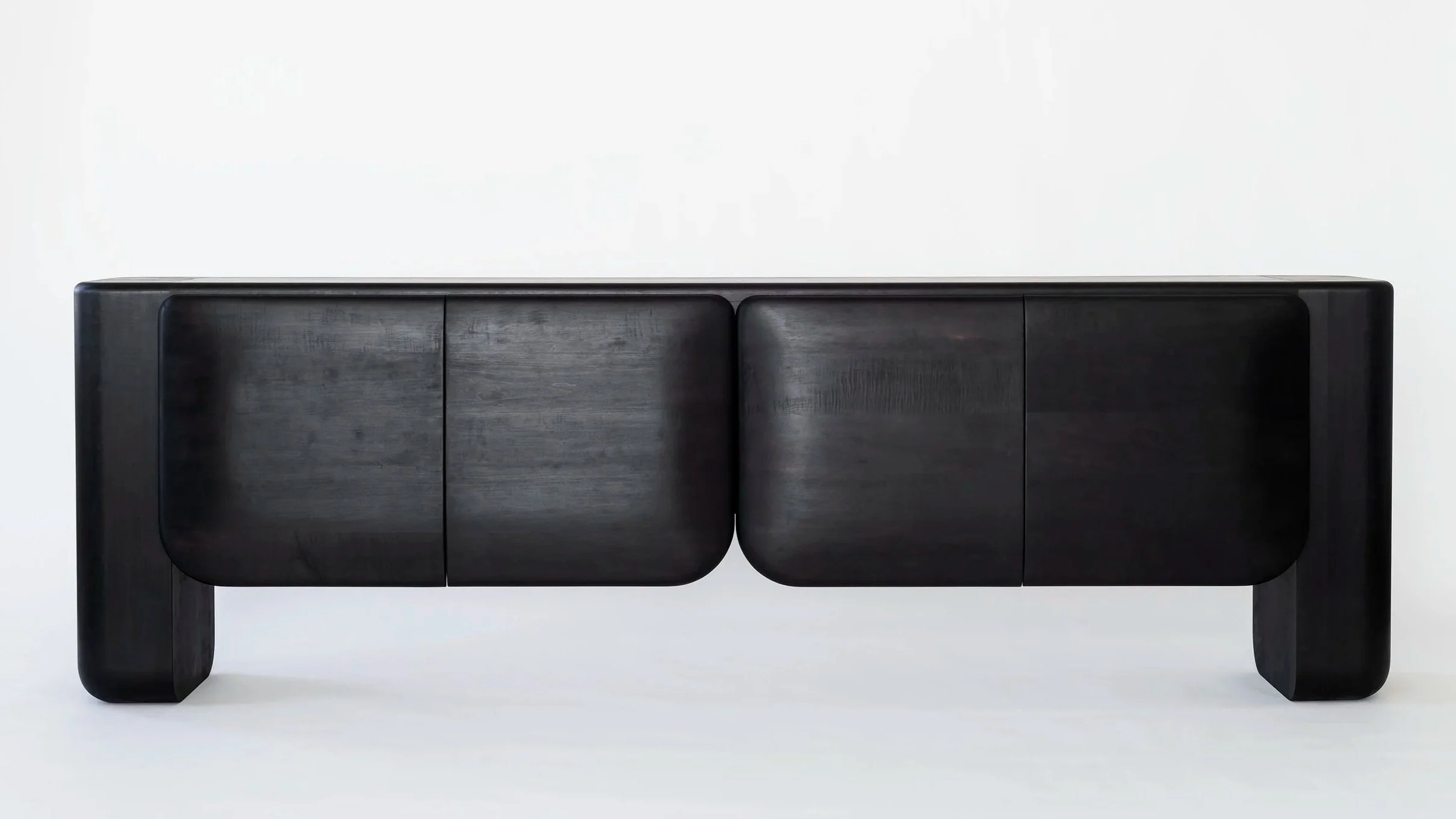 Bone Credenza shown on a white background. The Credenza is shape is sculptural and references bone like forms.