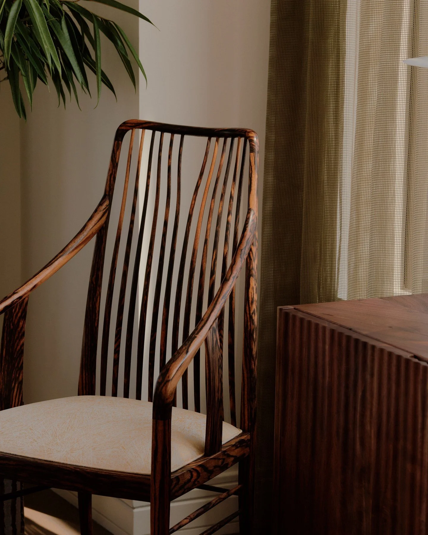 BLACK PERSIMMON CHAIR 02 - A quiet moment with the Black Persimmon Chair 02 (edition 2/2) by Master Toshio Tokunaga. ⁠
⁠
Created from extremely rare 100+ year old Black Persimmon wood + hand woven silk seat with gold pine needle relief - the chair is