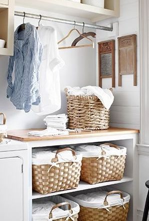 Baskets in a laundry room via countryliving