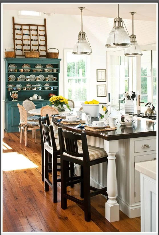 This is a vintage blue-painted cabinet with open shelves to store dinnerware that is right where you need it to set the table!! 