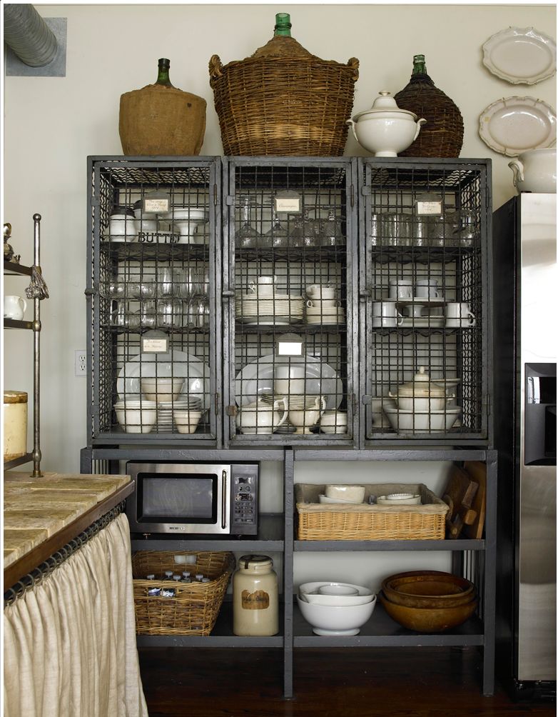 This is" a vintage French wine cage with metal shelves" that now stores tableware. Beautiful to look at and extremely functional! Can't beat that!!