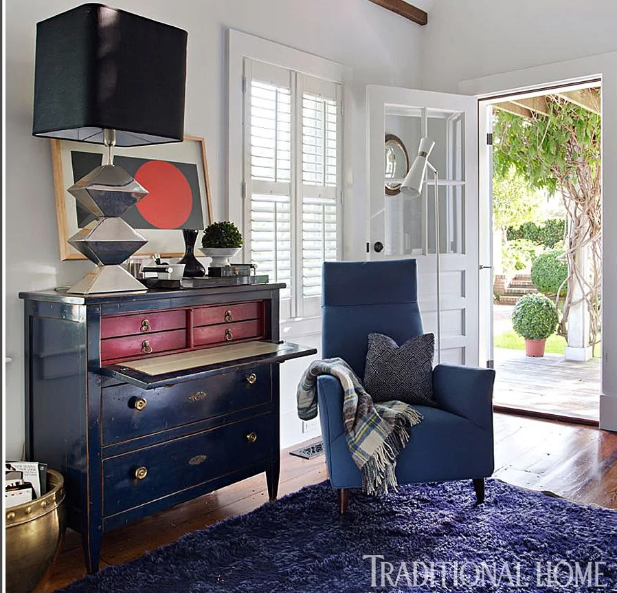This is a "centuries-old Directoire-style secretary—that came from a Paris flea market—serves as a dresser." I think this would be great for keeping mail and piles of paper out of sight.