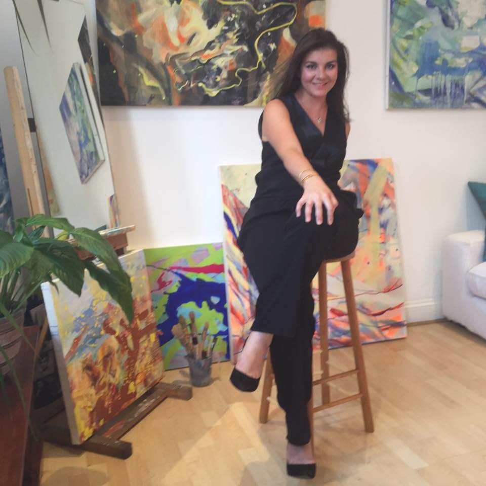 Minna George surrounded by her paintings