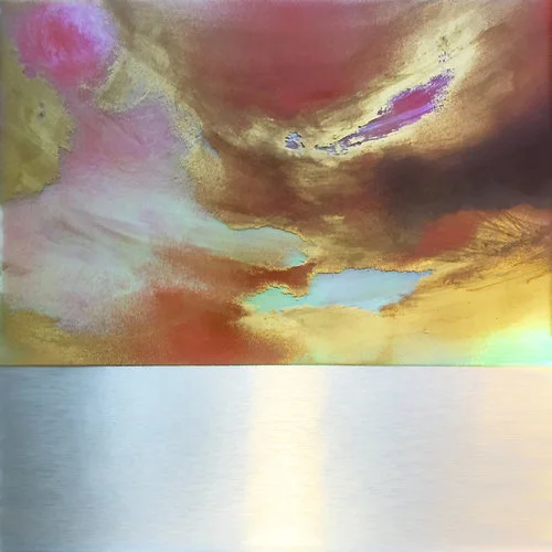 Plum and gold clouds and turquoise sky hover above a silver sea.