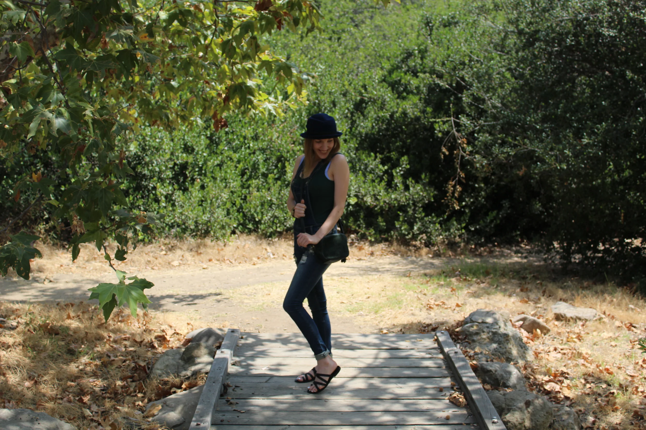 Overalls: Wet Seal // Tank: Banana Republic // Sandals: Ancient Greek, similar here // Bag: Ann Taylor, similar here // Hat: Boohoo Hello and Happy Monday! This outfit has been my summer go to as of late! Overalls are just so effortlessly easy and cool. I love these skinny type of overalls that hug your body and show off your shape. I paired them with an easy ribbed tank to add to the laid back element and to keep the look close to the body. I paired my matching green cross body bag to the tank. I love this purse and take it everywhere. It is so cute and holds quite a lot! The green is also perfect for all seasons! Now on to my favorite part... the shoes! I absolutely adore these criss cross sandals! I have never owned a pair of sandals with a toe strap but I must say I am quite a fan! These are the perfect everyday sandals and the strappiness of them keeps them right on trend and makes them easy to keep casual or dress up! To top it all off (literally!), I added one of my favorite hats... the pork pie. This hat always makes me feel extremely fashionable and fun! What are some of your favorite fun pieces in your closet? As always, thanks for stopping by and keep following for more new looks!!! xx Nicole