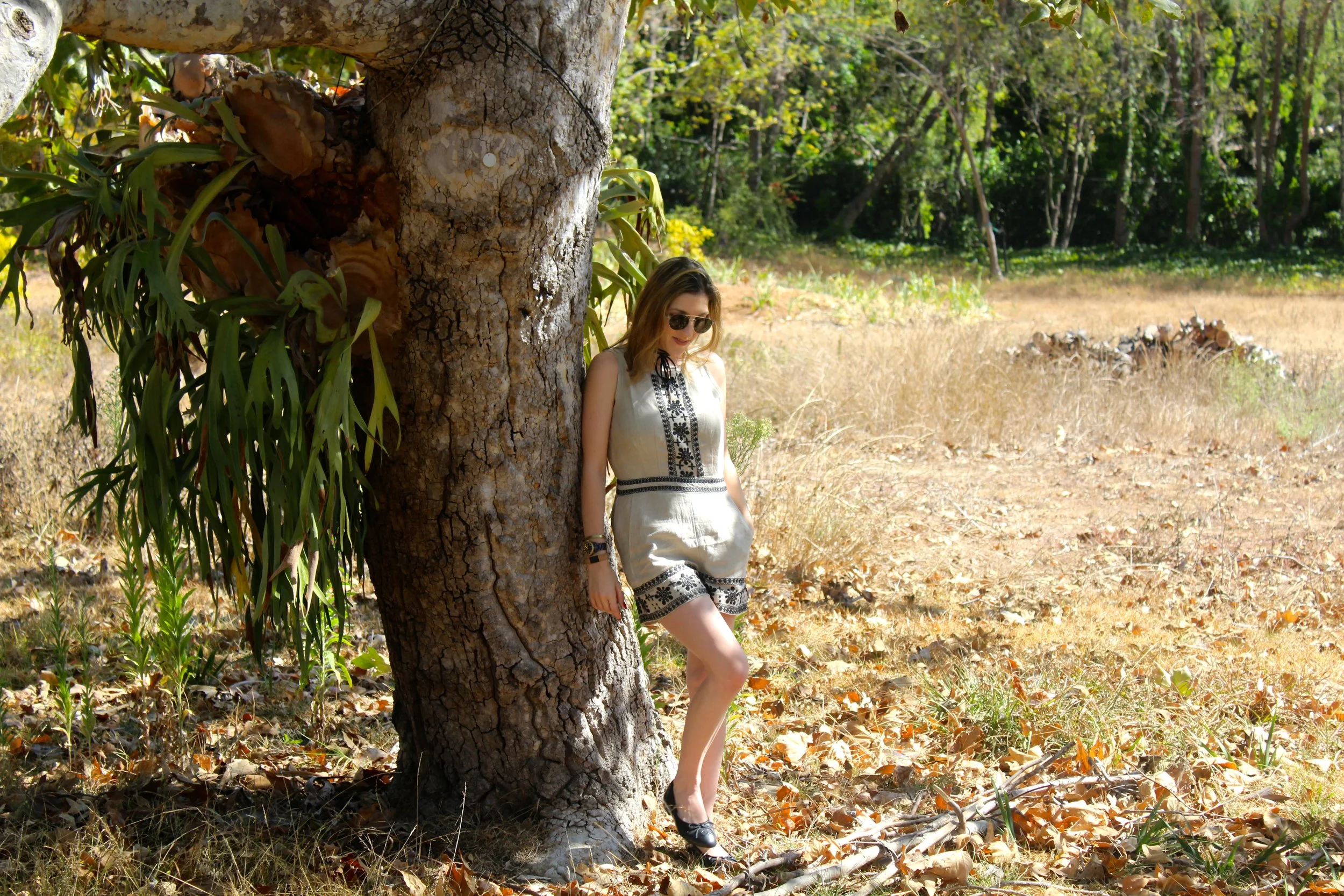 Romper: Loft ( ON SALE!!!) // Shoes: Chanel, similar here // Sunglasses: Le Specs // Choker: MakemeChic Fall is here, but it sure does not feel like it! The great thing about the weather staying hot through the start of fall is that you can score the best deals on summer sale! Case in point is this embroidered linen romper from Loft. It is so easy breezy, yet chic at the same time! As you can probably see from previous posts, I am a sucker for anything embroidered, so this look is right up my style alley! I love the tan linen mixed with the black stitching, this is always a perfect color combo in my opinion. I paired this look with my classic Chanel ballet flats and added an on trend wrap choker to keep this look contemporary and perfectly put together. Although it does not feel like fall yet, this background had me craving it with all the brown leaves and fall feels. Can't wait for it to start cooling down. Until then, I'll be staying cool in simply chic rompers like this one! As always, thanks for stopping by and keep following for more new looks!!! Ciao!!! xx Nicole