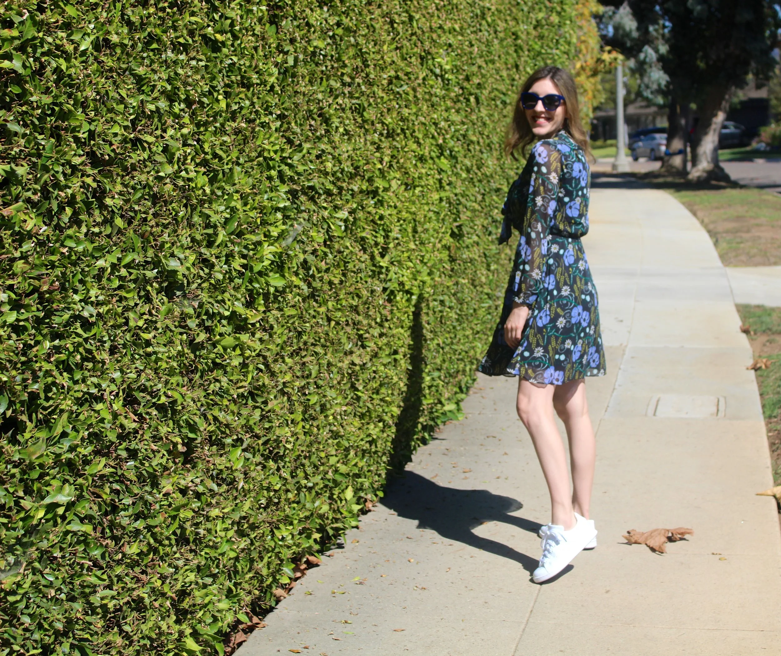 Dress: Banana Republic // Shoes: Adidas // Sunnies: Chanel This is a look I am loving right now with the weather being as stifling hot as it is! I love the contrast of a fancy dress mixed with the casualness of a sneaker. I never thought I would follow the Adidas Stan Smith originals trend, but I am glad that I did! These sneakers are super comfy but also look great with everything. I love the striking white of them and they look so cute when dressed up girly! Now onto this dress... I love that it is a dark floral which works perfectly for fall. When the weather cools down, I will be adding dark tights and an ankle boot to really bring this dress into true fall form. I also love that this dress has the added detail of a neck tie, which makes it even dressier so it can stand on its own if need be. Now if only the weather can match the colors on my dress!!! As always, thanks for stopping by and keep following for more new looks!!! Ciao!! xx Nicole