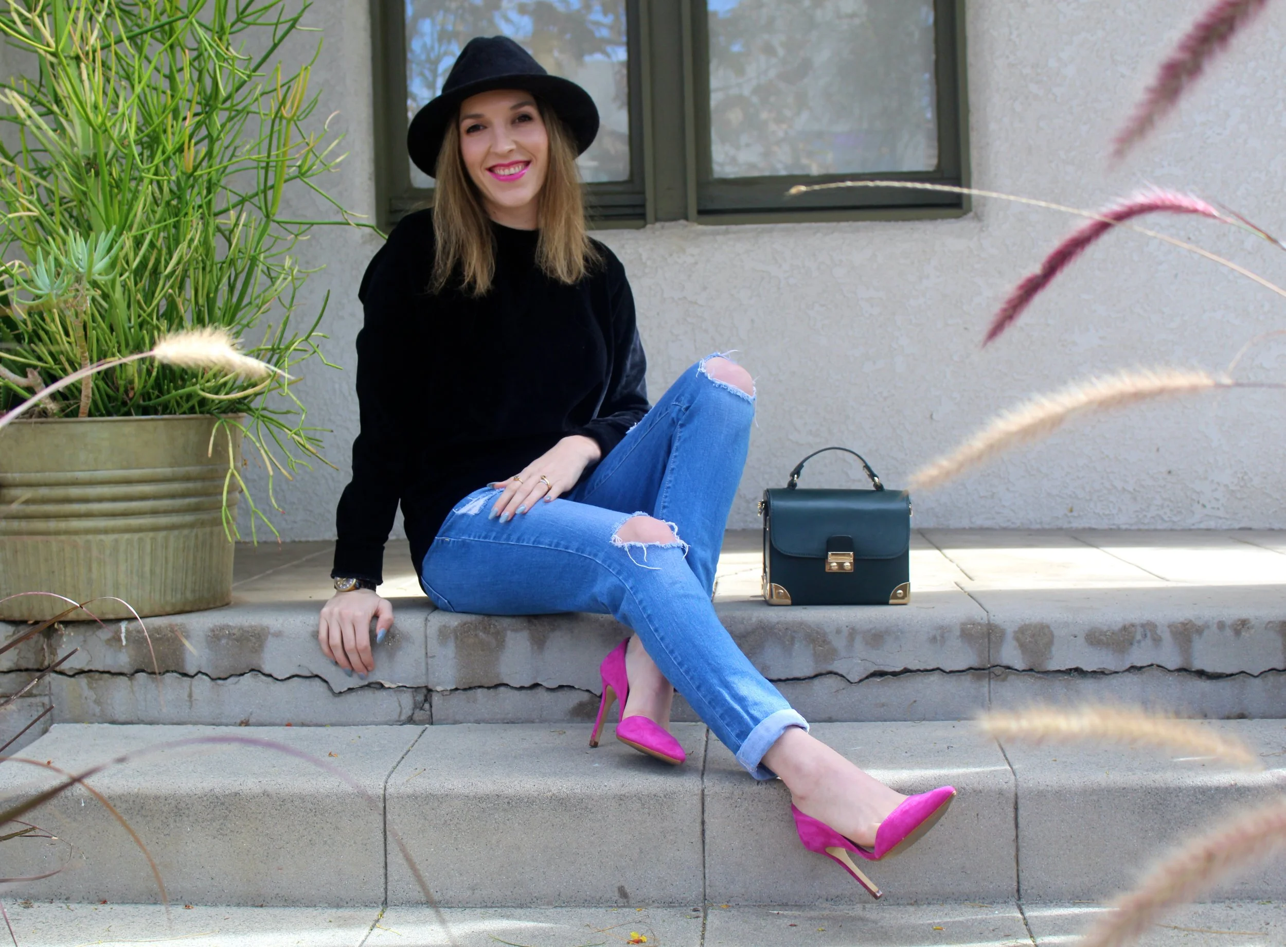 Top: Boohoo // Jeans: Flying Monkey, similar here // Heels: Banana Republic, simila r here and here // Bag: Forever21, similar here // Hat: Goorin Brothers, similar here Happy Monday from me! This is a simple look to be put together, with a mix of easy casualness and bright pops of color! I am all about a certain level of comfort when I dress, so a few wardrobe staples like a pair of boyfriend jeans and a nice soft pullover are always welcome! This black velour pullover that I am sporting, is super soft to the touch and right on trend with falls velour and velvet craze! I added a nice and bright pair of hot pink heels to keep my look elevated without trying TOO hard! I love pink so of course I had to match my lip to the shoe! Duh! And OMGeeeee, I love this simple but elegant bag I got from Forever21! I found it on a mannequin and had to take it, I have not seen it since, online or on anyone so I feel a little special! It is also the prettiest shade of green for fall and makes me feel super important like a doctor or a kid with their lunch pale on the first day of school! And of course talking about the subject of comfort and ease, on my bad hair days, I just throw on my go-to rabbit fur fedora and my look is complete and tres chic!!!! This is the kinda outfit I like to take from Sunday to Monday. Hope you all have a great Monday! xx Nicole