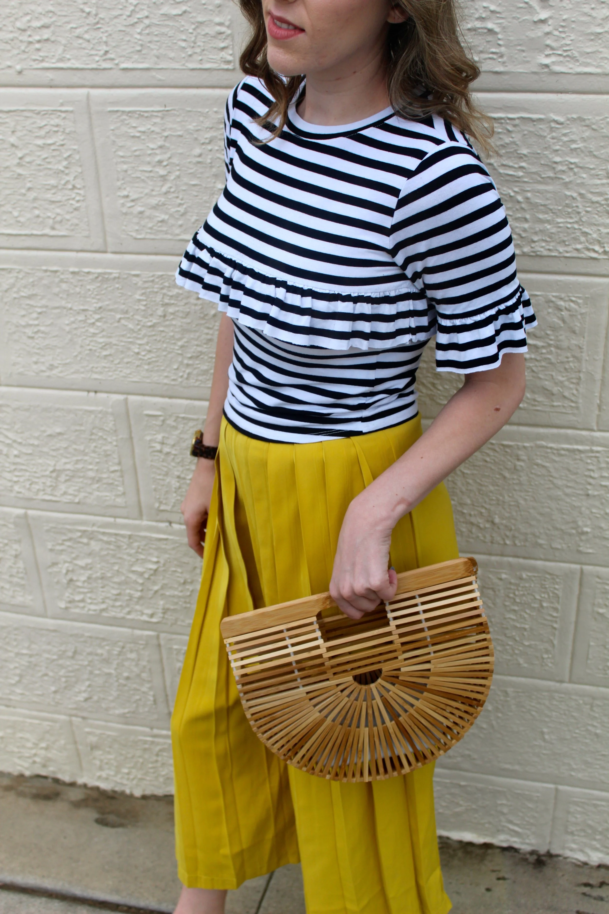 Top: Asos // Pants: Boohoo // Shoes: New Look // Bag: Cult Gaia I love color. Always have. Always will. Wearing bright colors always makes me feel happy too, which is another reason I can't get enough. It's like receiving endorphins without having to exercise! Strolling through Santa Monica, I stumbled upon the most colorful little houses, each unique in their color scheme. If you've ever been to San Francisco you know all about the colorful houses, but in Los Angeles it is not quite as common. I love that these houses were all unique in the bold colors they chose! Culottes are a trend that have come and gone times before, but in my closet, they are here to stay. I love the effortlessness of culottes but yet they always look tailored when paired with a cute top and heels! These bright yellow pleated ones are my new favorites because of the breeziness of them. The fit is so comfy but they also look very put together. And... of course they are bright and yellow! I am also a huge sucker for anything with stripes so this top is right up my alley! Plus the ruffles really make it a unique top and super girly! Now onto my favorite new bag... my Cult Gaia carry all! I have been waiting on this beauty for a few months now! It is only available by pre-order and I finally received mine! It is a representation of a Japanese style picnic basket. The bamboo on this bag is super durable and unique looking. If you want a bag that is one of a kind but super stylish, I suggest pre ordering one of these babies for yourself! Thanks for stopping by and keep following for more new looks!!! xx Nicole