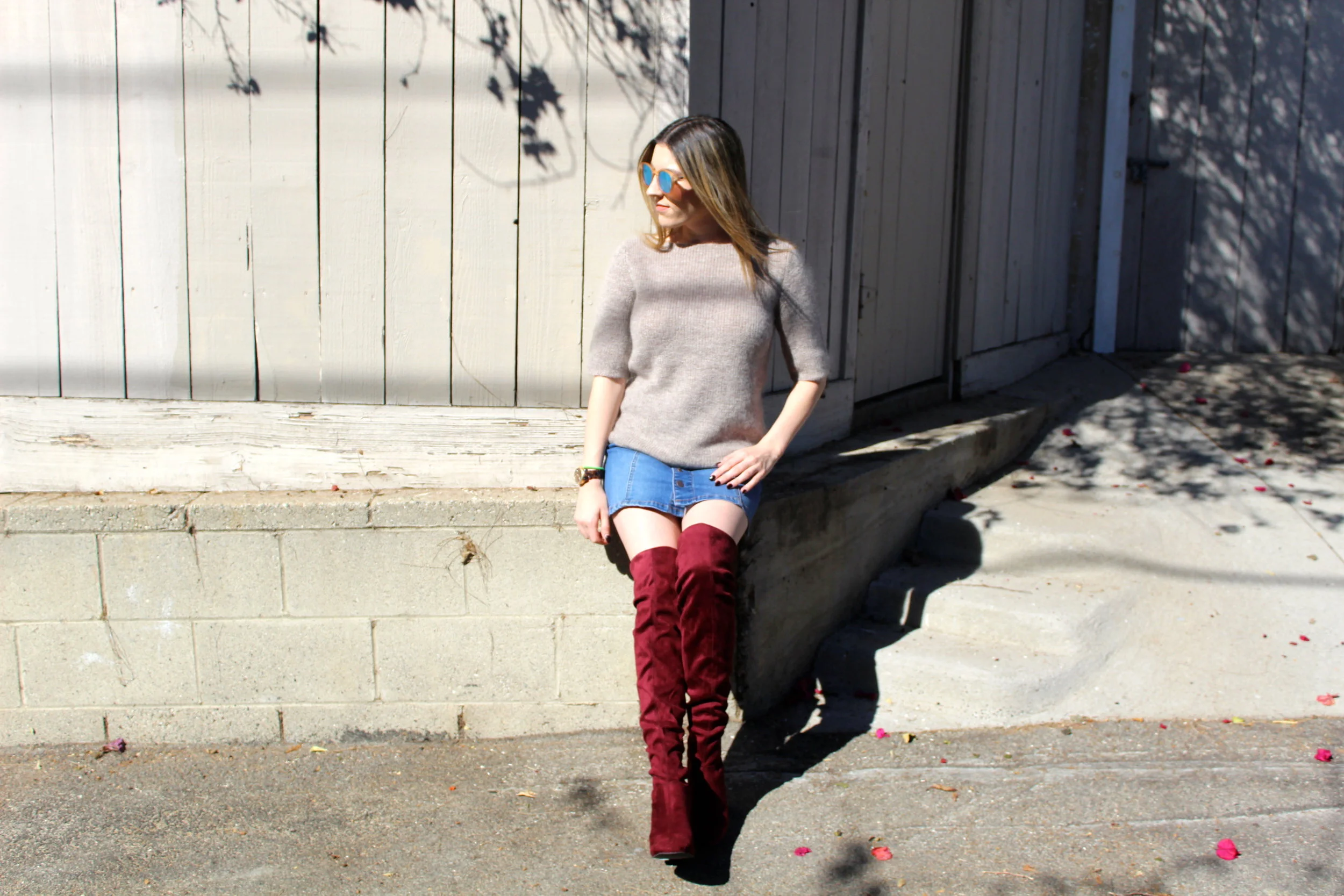 Boots: New Look // Skirt: American Rag, similar here // Sweater: Banana Republic, similar here // Sunnies: Le Specs, similar here Over the knee boots are one of the hottest shoes for the fall and winter season, and these red ones are to die for! In a previous post I shared all of my fall cravings, and these stunners were definitely on that list! I finally snagged myself a pair and oh how I love them! I decided this year to go with a pair that was an unconventional color like these red ones because I already own a brown pair and most likely will be adding a black pair to my closet. These type of boots can dress up the simplest of outfits and make anyone wearing them feel like a million bucks! I chose to style this look with a cute little button down denim skirt and an oversized mohair sweater, which I love! I really wanted these boots to stand out and be the sexy little stars that they are! Finally I put on my new mirrored Le Specs sunglasses, another new closet fave! This look is absolutely one of my favorites and screams fall to me. Wear and repeat is my new motto with this look! Thanks for reading! xx Nicole