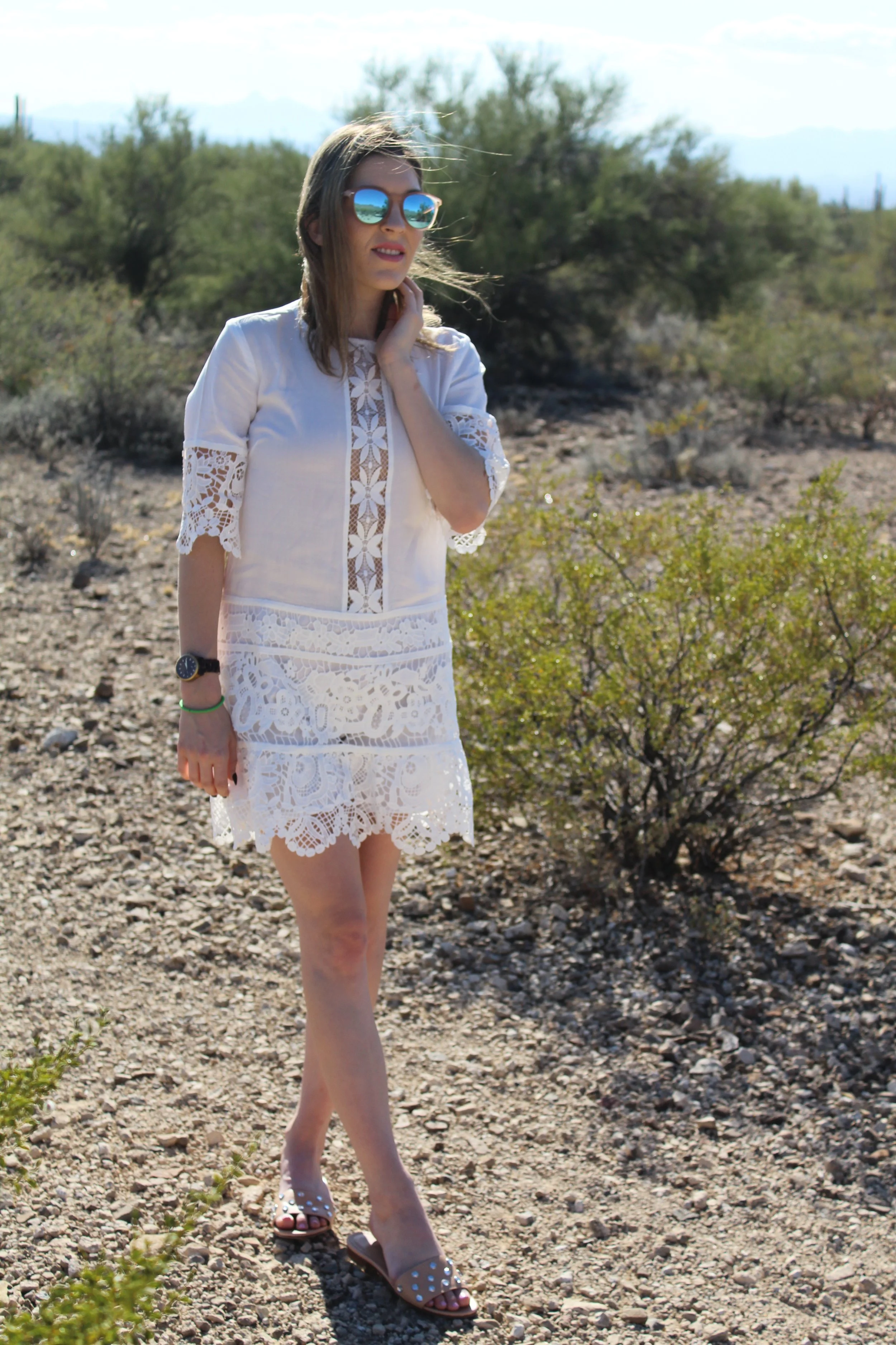 Dress: Endless Rose ( On sale!!!) // Sandals: Banana Republic, similar here // Sunnies: Le Specs Warning : Desert overload in this post! I have said it before and I'll say it again, I love the desert but especially my home away from home, Tucson. It is the most beautiful and welcoming city. Just look at the sky and colors of this post and you can feel the desert sun shining on your back. The real beauty of this post really is this white lace shift dress though. What a stunner! I am a huge advocate of lace, I say put it on anything and pair it with anything! I love the lace detailing on this dress and where the lace was chosen, it makes it really stand out! A white dress is really perfect for any season. You could wear this right now for winter with striking black tights and over the knee boots or you can wear it in the dead of summer while walking the beach with your bikini on underneath. I chose to add my studded slides with it to keep the pretty and girly feel of it all. Then popped on my favorite sunnies currently, my mirrored Le Specs! This look, for me, was made to walk the beautiful landscapes of the desert, but for you maybe it's the mountains, the beach, or your backyard garden. Fashion is where you take it! What are some of your favorite lace pieces? Thanks for stopping by! xx Nicole