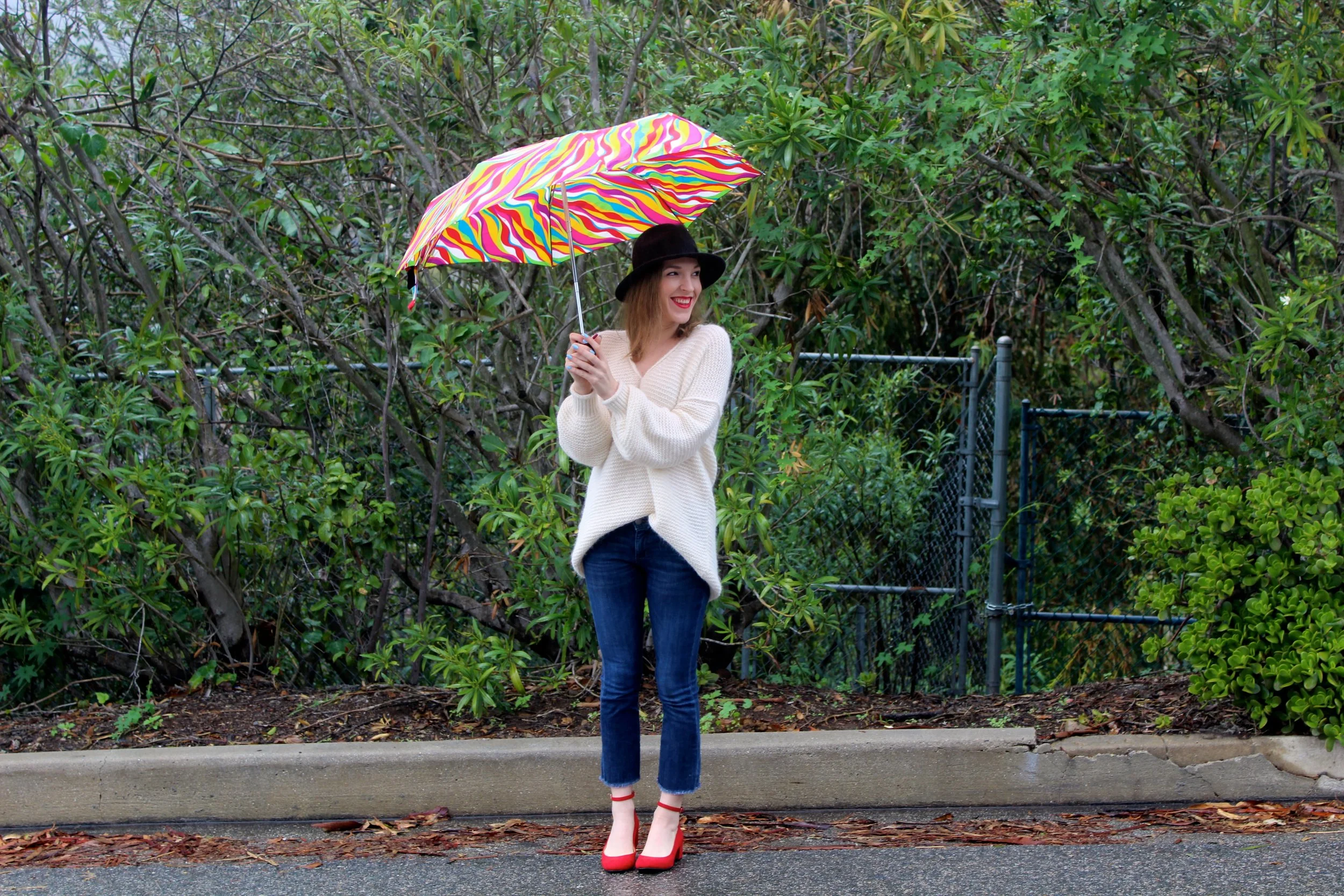Sweater : Free People // Jeans : Banana Republic, similar here // Shoes : Chinese Laundry // Hat : Goorin Bros. // Lipstick : Bobbi Brown // Umbrella : Old, similar here It has been raining here in L.A. and so there is no better feeling than being nestled up in a cozy sweater. Hence the term sweater weather right? This sweater from Free People is all parts cozy and chic! I love the oversized-ness of it but the bell sleeve arm detailing and alpaca wool amp up the chicness! I love wearing all white too! It makes me feel so fresh! I paired this beautiful winter white sweater with a deep hue of red on my feet and on my lips! These shoes which my sister bought me for Christmas are ones that I absolutely adore right now! The heel is a cute but manageable height to wear all day long and the ankle strap detailing adds that extra pop! This Bobbi Brown lipstick in the color Red (also a gift from my sissy), js one of the hardest shades of lipstick to find! It is almost sold out everywhere except for a few places like Blumercury, linked above. The red is so rich and smooth, I think I have worn it everyday since I got it! Thanks Jack! I don't want winter to end because I want to stay snuggled up in all of my cozy and fuzzy sweaters! Thanks for following and keep checking in for new posts! xx Nicole