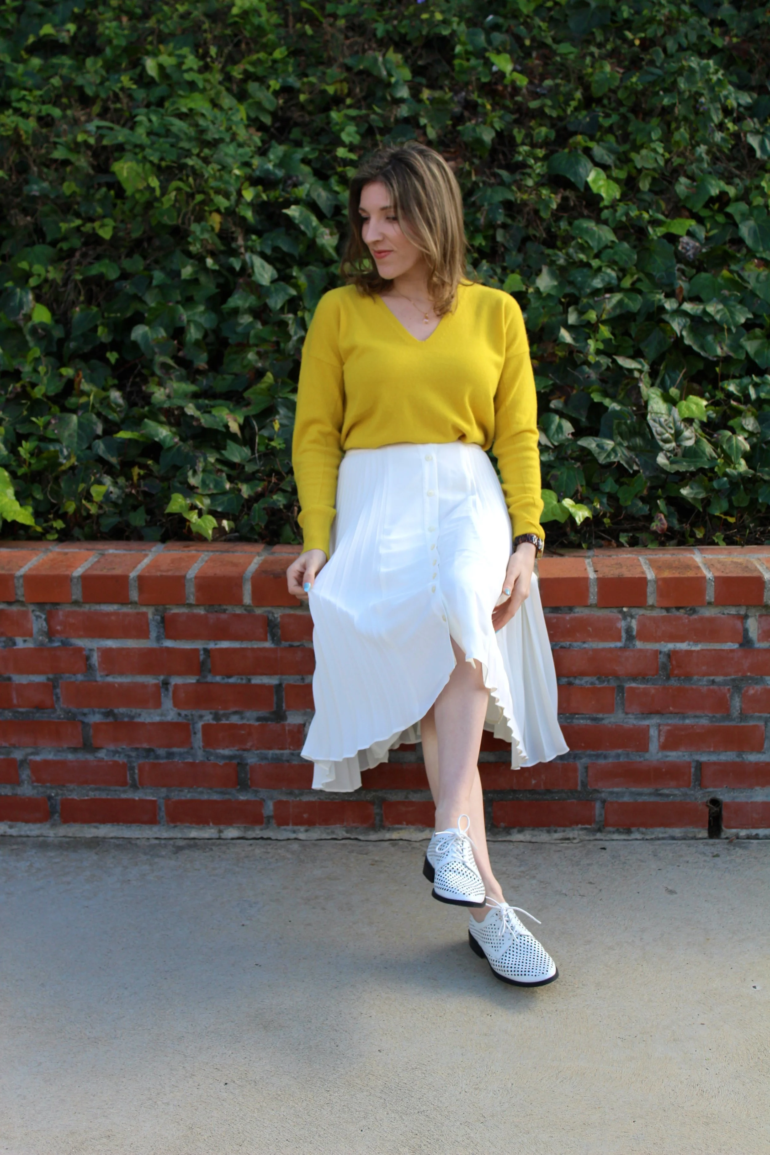 Top: Banana Republic, similar here // Skirt: Banana Republic, similar here // Shoes: Forever 21, similar here It sure has been raining a lot here in Los Angeles! As much as I love the rain and as much as we do need it, I am looking forward to my bright and sunny spring weather. This past week we had a clear somewhat warmish day, so of course I took full advantage. And although the weather didn't really permit for me to wear this, I had to anyways. I am craving spring and sunshine. How fun is this bright yellow cashmere sweater?! It is so soft and I am in love with the color. Such a pop of fun! And who doesn't like to don a soft cashmere sweater? I have been living in them all winter long! I have worn this beautiful white midi skirt in a previous post, but by pairing it with a tucked in sweater, it changes the look all together! I love having pieces in my closet that are interchangeable and with one tweak can be totally transformed! I threw in a fun white oxford shoe to tie the whole look together and scream SPRING! I love this white and yellow color combo for spring as well! Hopefully the rain will bring a beautiful spring full of beautiful flowers and brightness! Looking forward to my new spring wardrobe as well! Stay tuned for new posts! As always, thanks for stopping by! Have a great Wednesday friends! ~ Nicole
