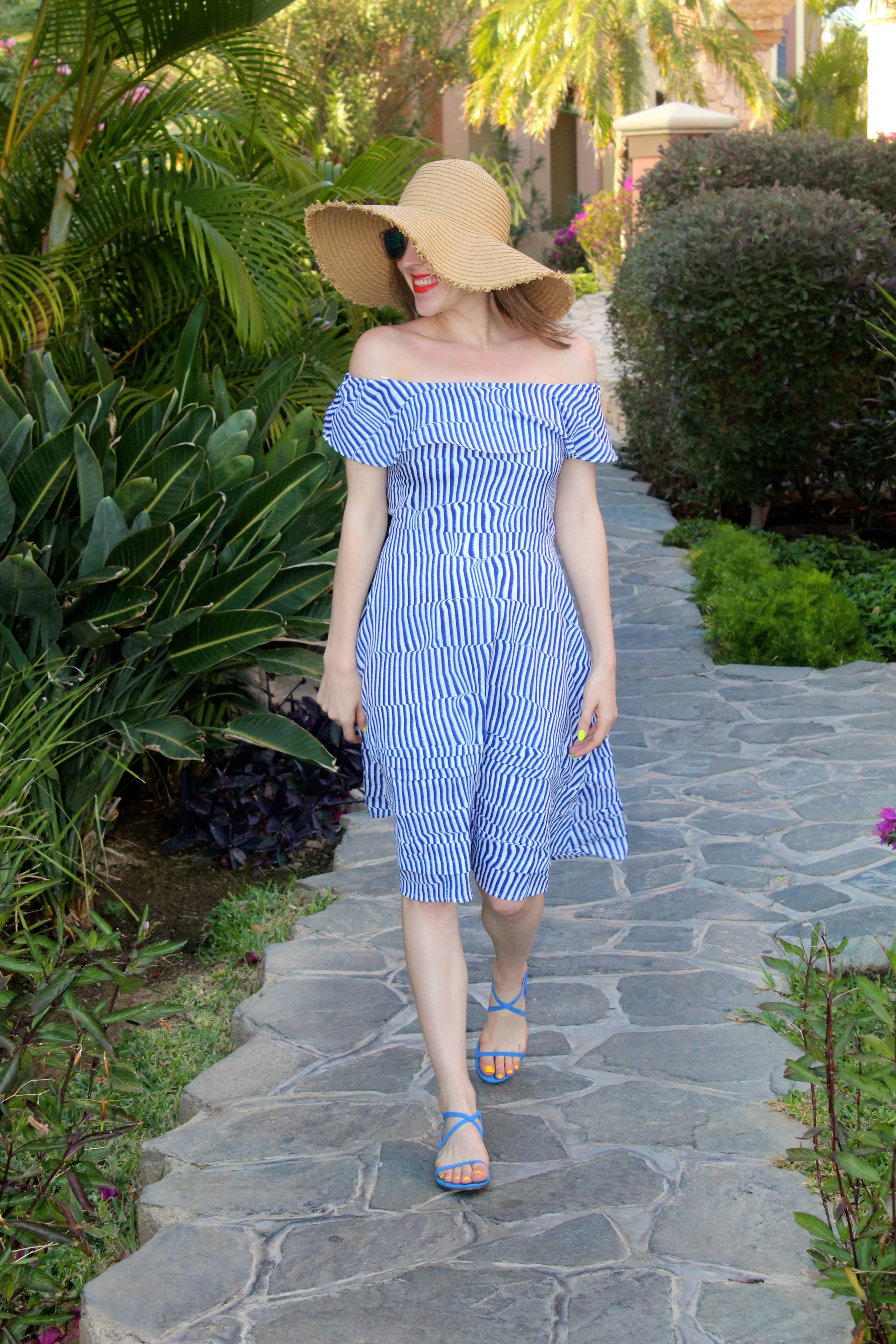 Hat : Forever 21, similar here // Dress : Banana Republic // Shoes : Banana Republic, similar here // Sunnies : Le Specs Well.... I'm back home and reality has set in that vacation mode is over. It is always sad when vacation comes to an end, but then again I am happy to be home and get back to my puppy boy. Cabo San Lucas was an absolute joy! The weather was perfect, the beach and pool were beautiful, and the resort was one of the most architecturally stunning ones I have ever been to! I am already dreaming of where I am going to go to on my next vacation! Tropical destinations and weather always calls for bright colors and easy breezy clothing options. My suitcase consisted of bathing suits and dresses, both of which I wore on a daily basis! This dress above made me think of the ocean when I saw it, so I knew it would look perfect in front of a beach backdrop when I wore it and yes, I was right! I brought my bright blue sandals out and threw on my favorite beach hat and this look was perfection! Maybe next, I'll take it to Santorini! Hmmmm.... now there's an idea! Till next time! ~ Nicole