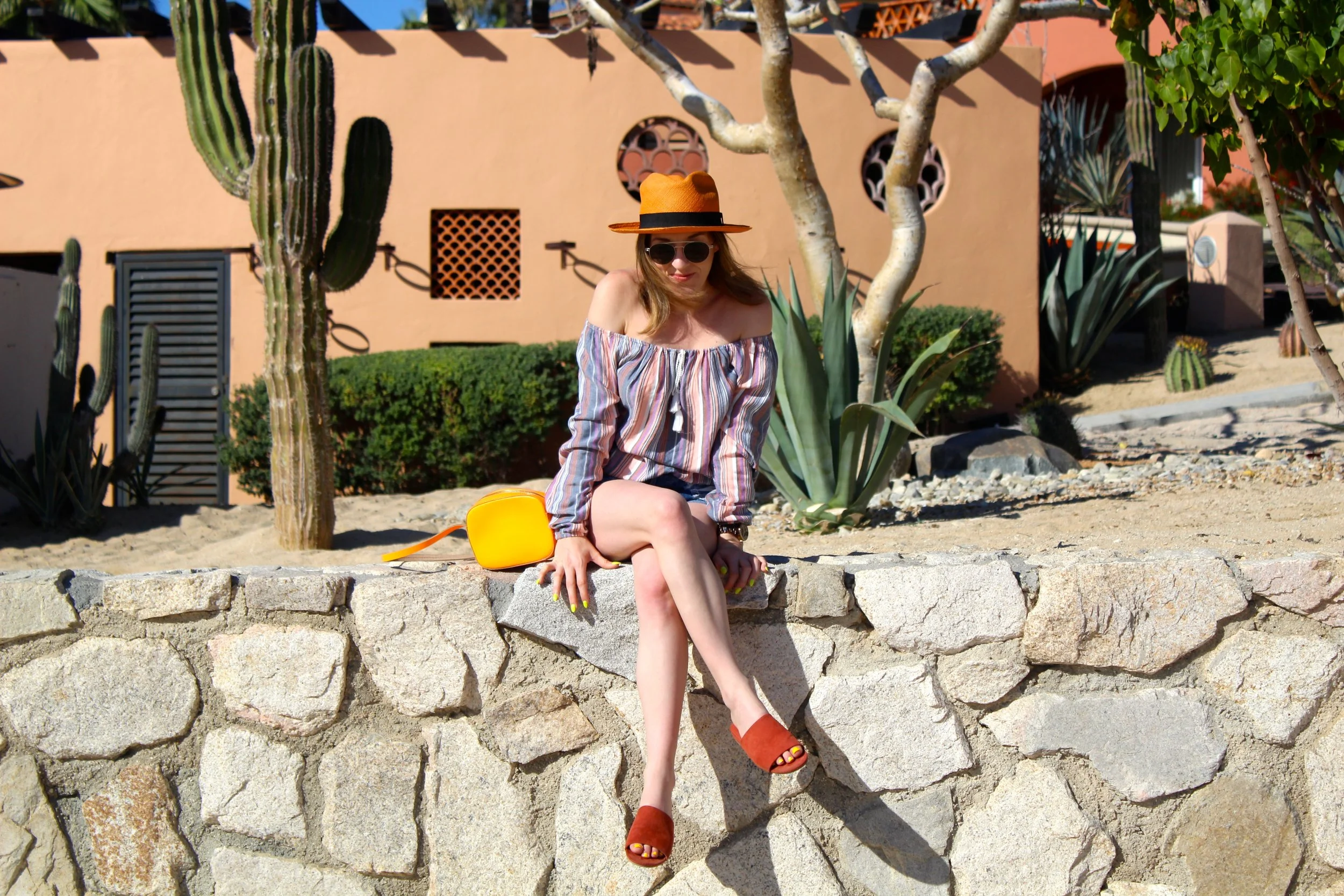 Hat : old, similar here // Sunglasses : Le Specs // Top : Hollister, similar here and here // Shorts : MinkPink // Shoes : Forever 21 // Bag : J. Crew, similar here It is still taking me a minute to adjust to the fact that I don't get to wake up in paradise every morning! Luckily I have all of my photos to take me back to the beauty of Mexico. One of the things I have always admired about Mexican culture is the color! I am a huge lover of all things color. So with so many colorful things around me in Mexico, (i.e. the flowers, the buildings. my obsession with orange apparently),I was a very happy girl! My wardrobe definitely fit right in to my surroundings. From the photos you can see that the resort I stayed in loved orange just as much as I did! Orange I glad I stayed there! Tee hee- just a little orange humor for your Friday! Everything I am wearing in this post are some of my closets' key pieces. If you follow me, then you have probably already seen my purse, my slides, my sunnies, or my hat in many previous posts. My orange panama hat that I actually bought in Panama, is one of my favorite hats that I have ever owned. I love the brightness of it because it adds an instant cool factor to any outfit I put it with. My sunglasses are just great because they actually fit my tiny face. Yes this is a problem in my life. The color of these slides is what really sold them to me and they are just so easy and effortlessly chic to wear around town or at home! And since I just went on and on about my love for color, the purse is a no brainer! LOL. An off the shoulder top is always good to have whether its a basic or a little more fun like this striped peasant style one above. They are great for the summertime, for vacation, and nowadays, even for going out or events! I love the softness of the colorful stripes on the one above. Although it is no longer available, I have linked a few just like it above. Now I just have to wait a little while longer to be able to pull it out of my closet again. I am thinking for the spring/ summer months, I will pair it with overalls or a maxi skirt. As always, thanks for dropping by and have a lovely weekend! ~ Nicole