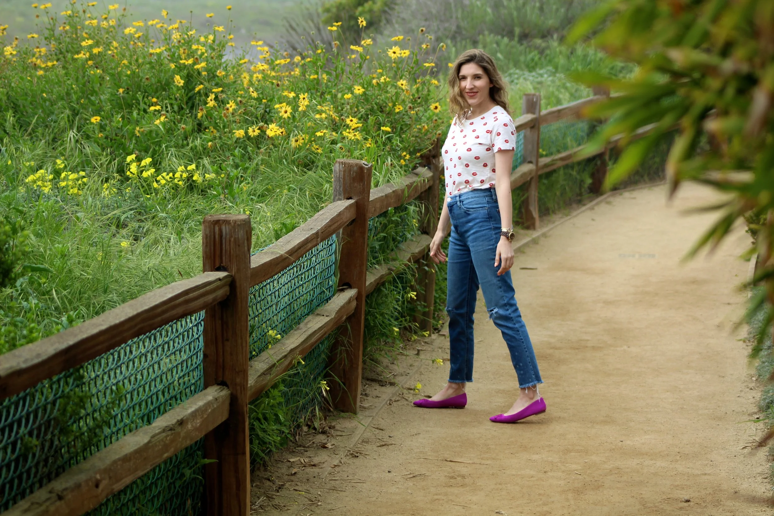 Top : Forever 21 // Jeans : BDG // Flats : Banana Republic // Hat: Goorin Bros. // Purse : Forever 21 // Cuffs : Asos ( similar here ), Kendra Scott // Watch : Michael Kors Spring is officially a week away! The flowers are blooming, the sun is shining ( not so much on this day), and the colors and prints of spring in the fashion world have sprung! I can not be more excited for it! It has been a long, cold, and VERY wet winter here in Los Angeles so I am welcoming the change of season! It is no secret that I love color, especially bright bold colors so these flats are right in my wheelhouse. I love the color, it is even more rich in person. Although I wear color year round, most people only pull it out for spring and summer. I think color always adds an extra pop to any outfit so if you are someone who is shy about color, why not add it into your shoes or accessories to start? This top has become one of my current favorites. First off, I love the print! The bright red lips are so fun to rock! Secondly, it is a tee so it is effortless and super comfy to wear all day long. But the best part... It is under $10! Such a steal! I am imagining so many things to do with this t-shirt, but next I think I'm gonna pair it with a black blazer and dark skinny jeans. I love a good pair of skinny jeans, but recently I have fallen in love with these "mom" style jeans! They are actually really flattering, can't you tell? Tee hee. My favorite part about them is that I can wear flats with them and it doesn't make me look frumpy! Score! Although I love to wear jeans, I am ready to pull out my skirts and dresses! Spring, I'm ready and waiting for you! As always, thanks for stopping by and have a lovely week friends! ~ Nicole