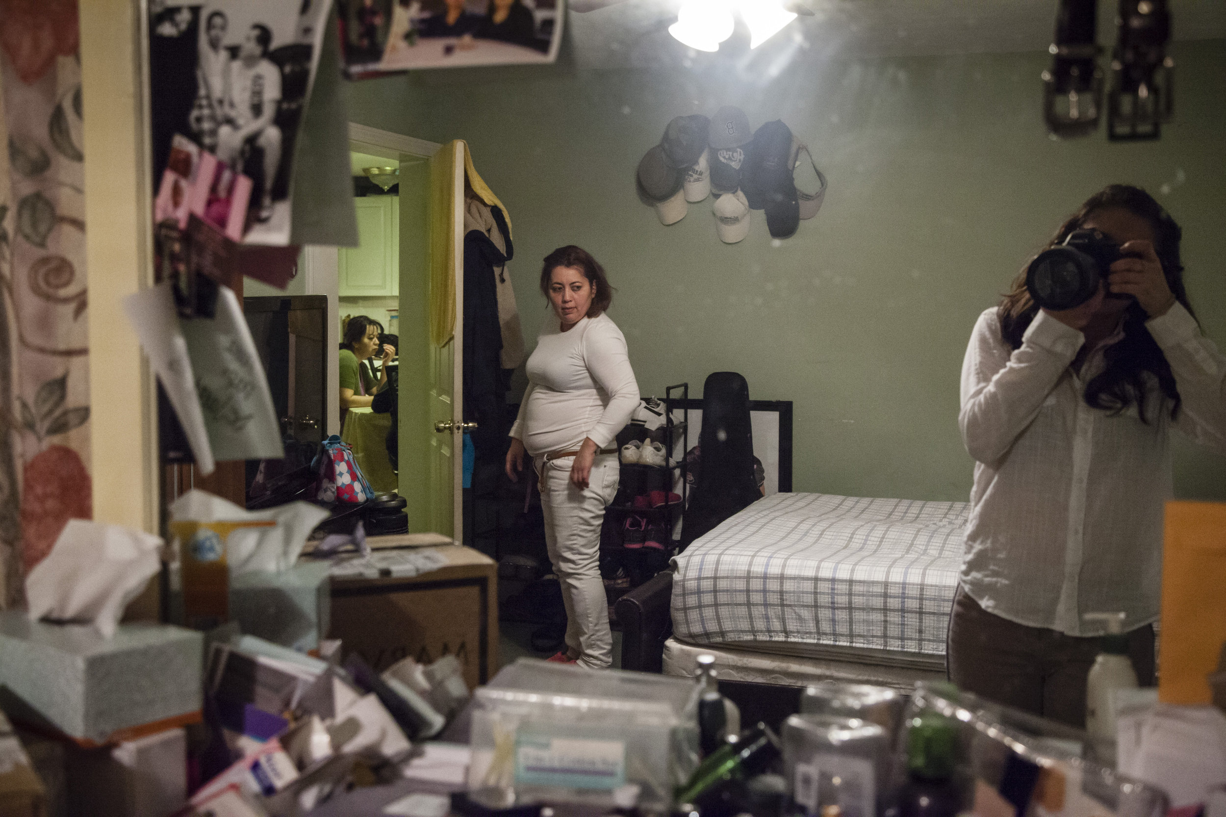 My aunt, Maritza, stands in her home after a 12-hour shift at the factory. She is the first of our family to immigrate to the United States. “If I stayed, I would’ve probably had five kids conforming to the typical Salvadoran lifestyle. You don’t progress over there. I own my car now and, one, day I will have my home.”