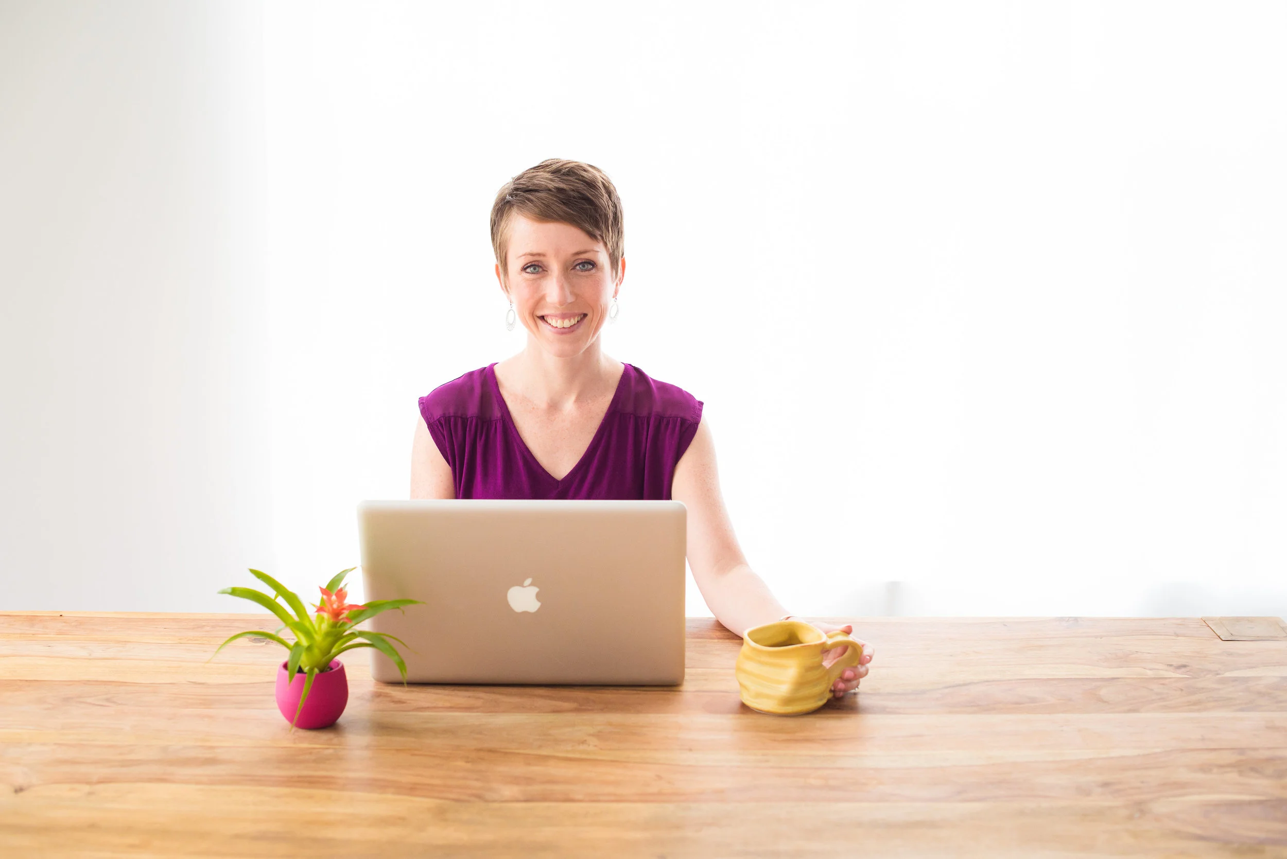Horizontal - desk, hand on mug.jpg