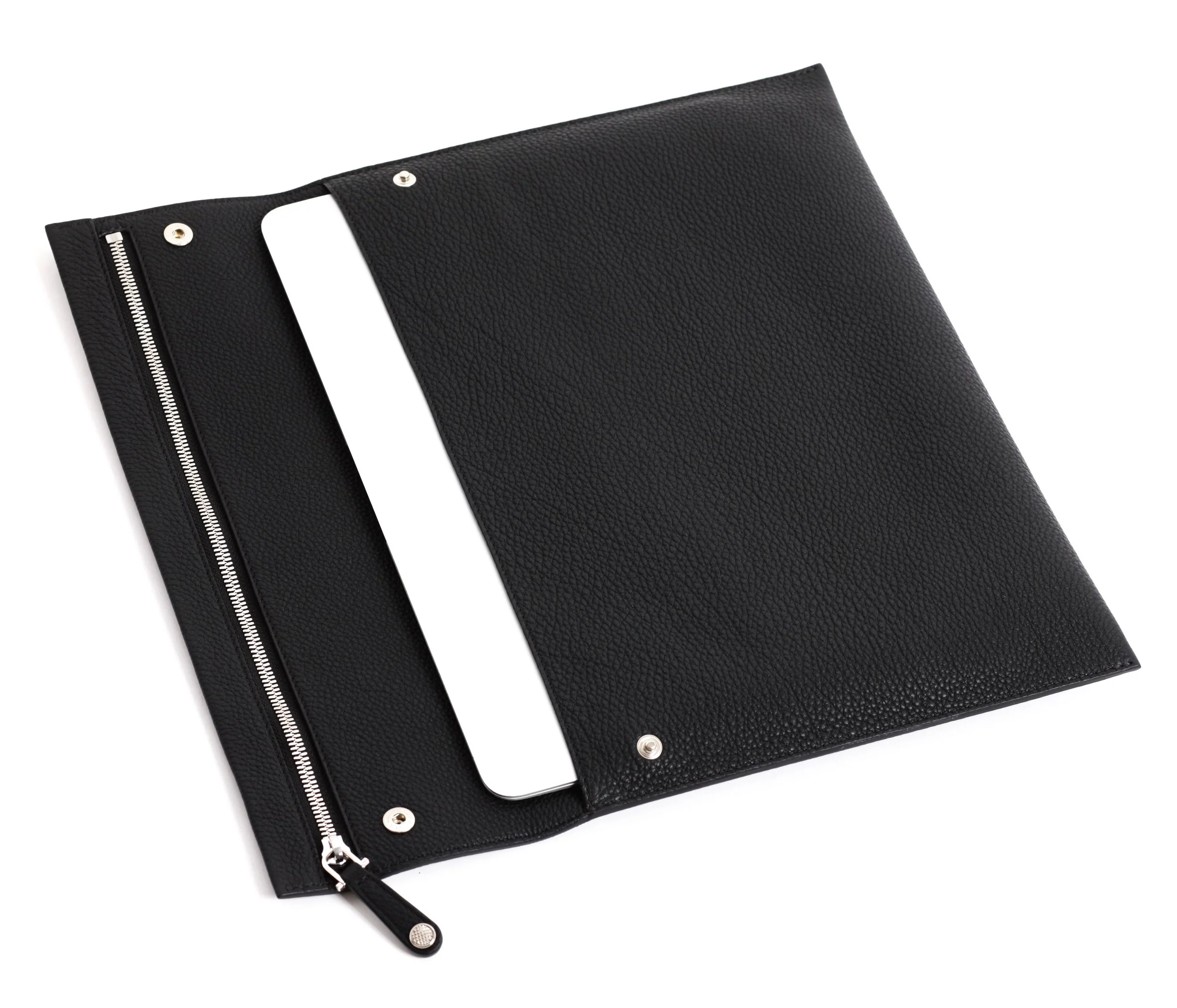  I-pad or laptop carrier, can be used as a stylish document carrier too. One single piece of Tourillion leather folded and sewn into a pocket with flap. 