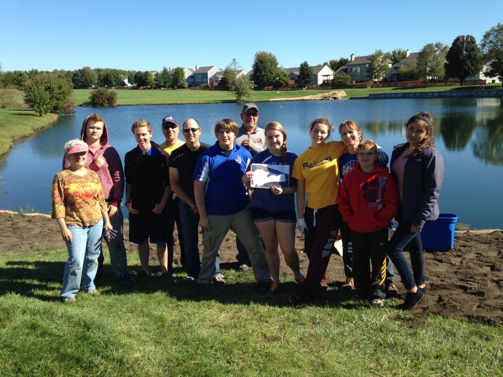 Michelle Gangel (third from right) with her daughter and neighbors creating the butterfly garden.