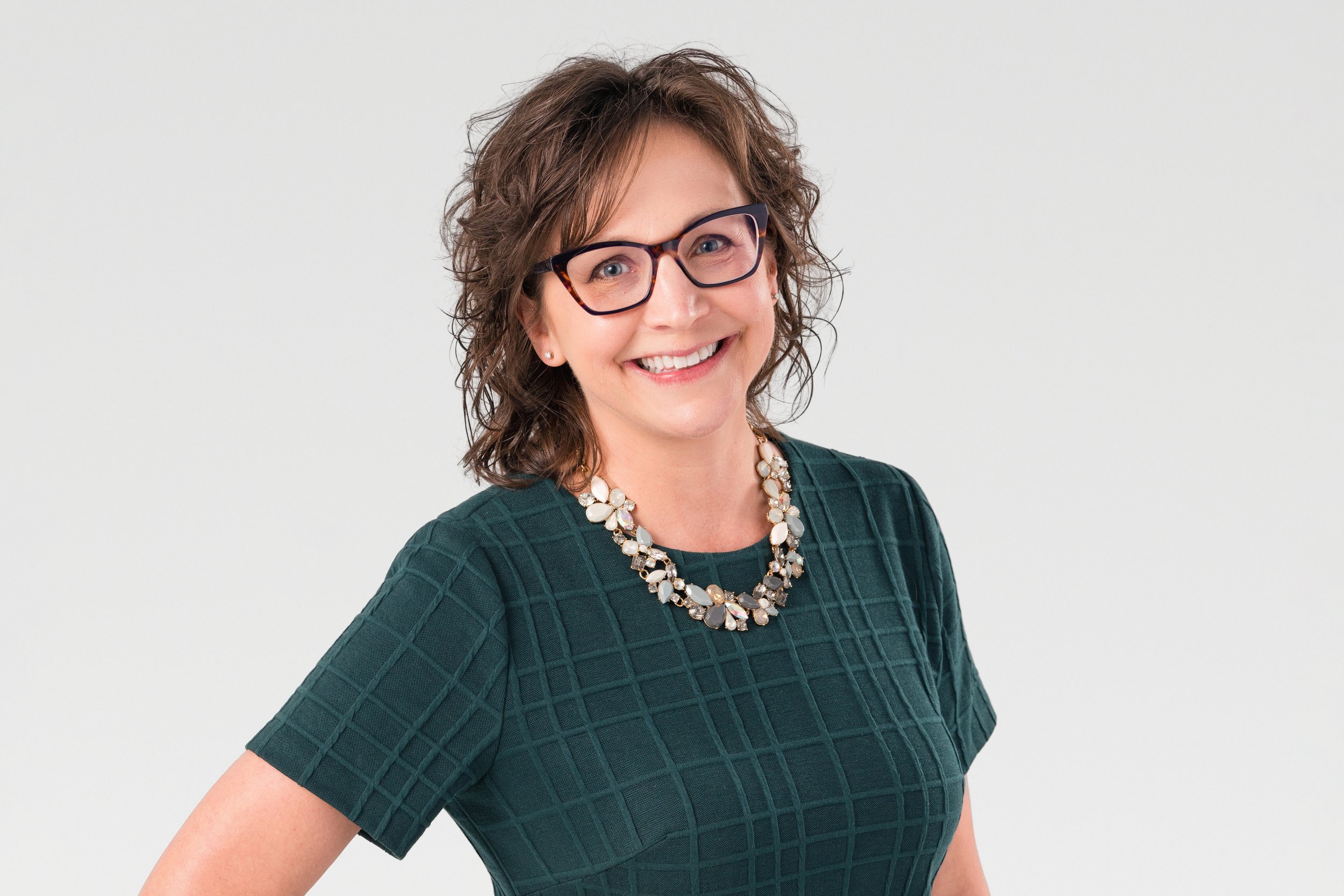 woman in a green dress and glasses