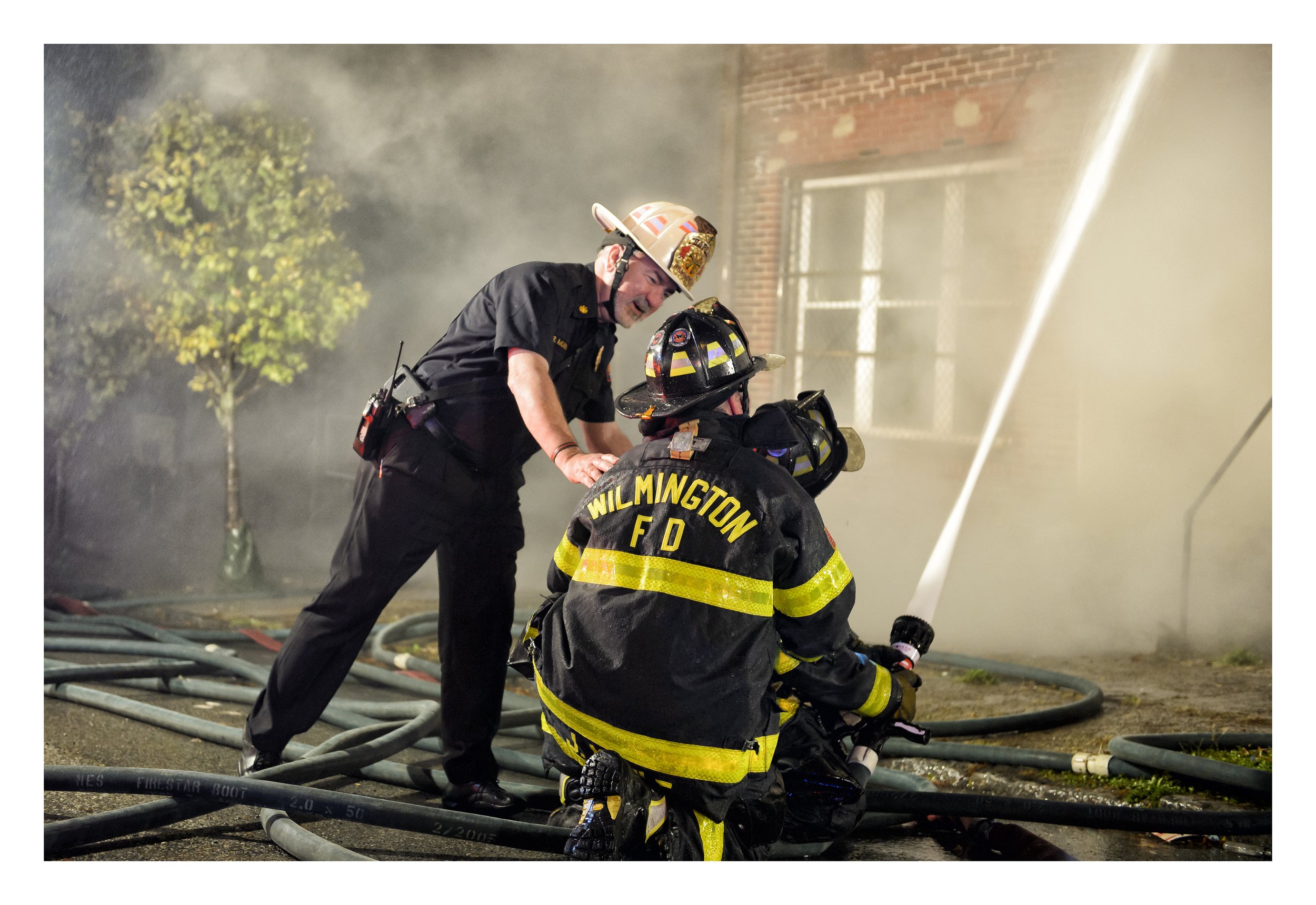 Rev. Michael S. Murray, OSFS, Assistant Provincial and Chaplain for the Wilmington Fire Department, supports Senior Firefighter Frank Maule during a house fire in downtown Wilmington, DE.  