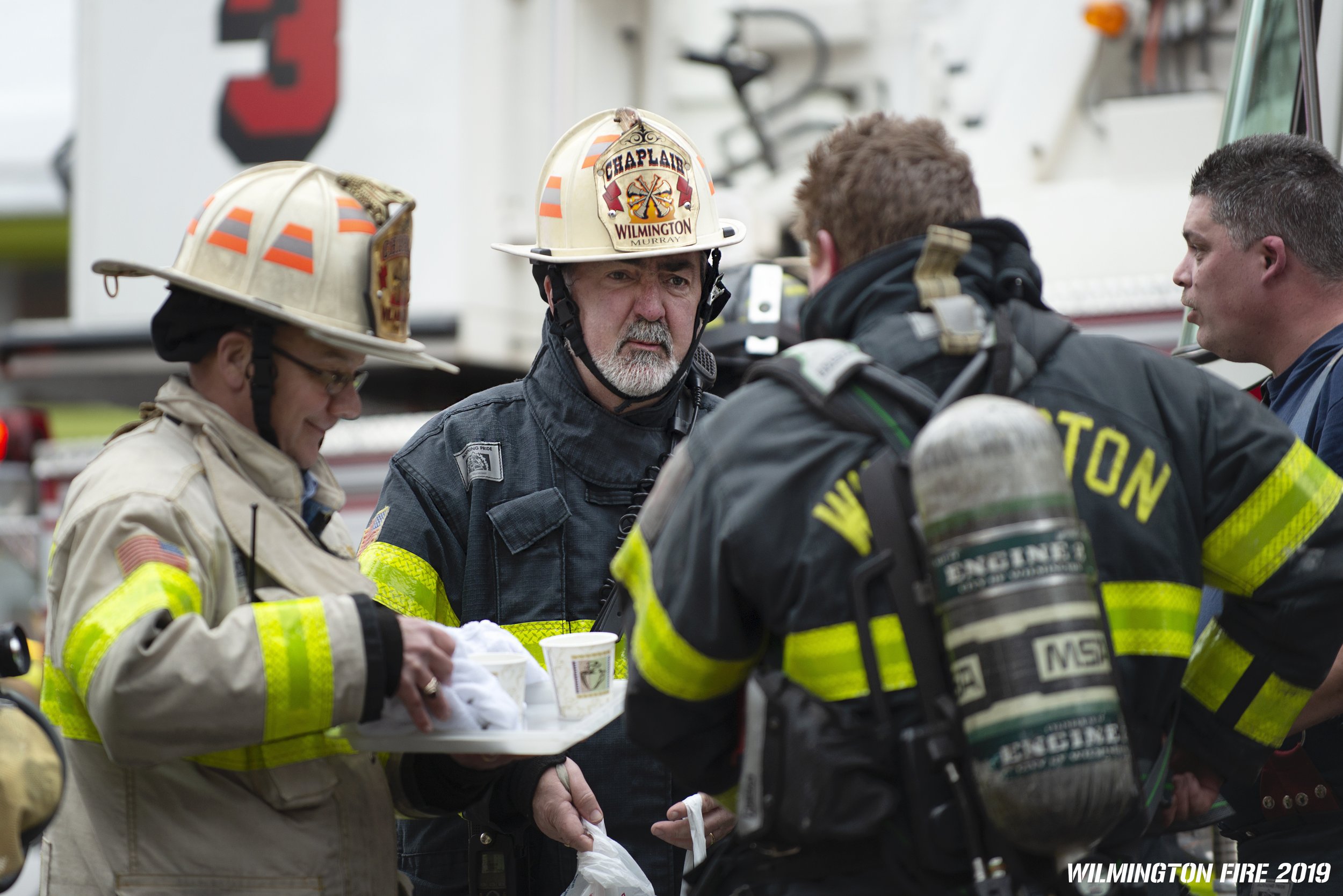  Rev. Michael S. Murray, OSFS, Assistant Provincial and Chaplain for the Wilmington Fire Department (WFD), confers with his fellow chaplain, Rev. Brad Martin, and WFD firefighters at a recent fire. 