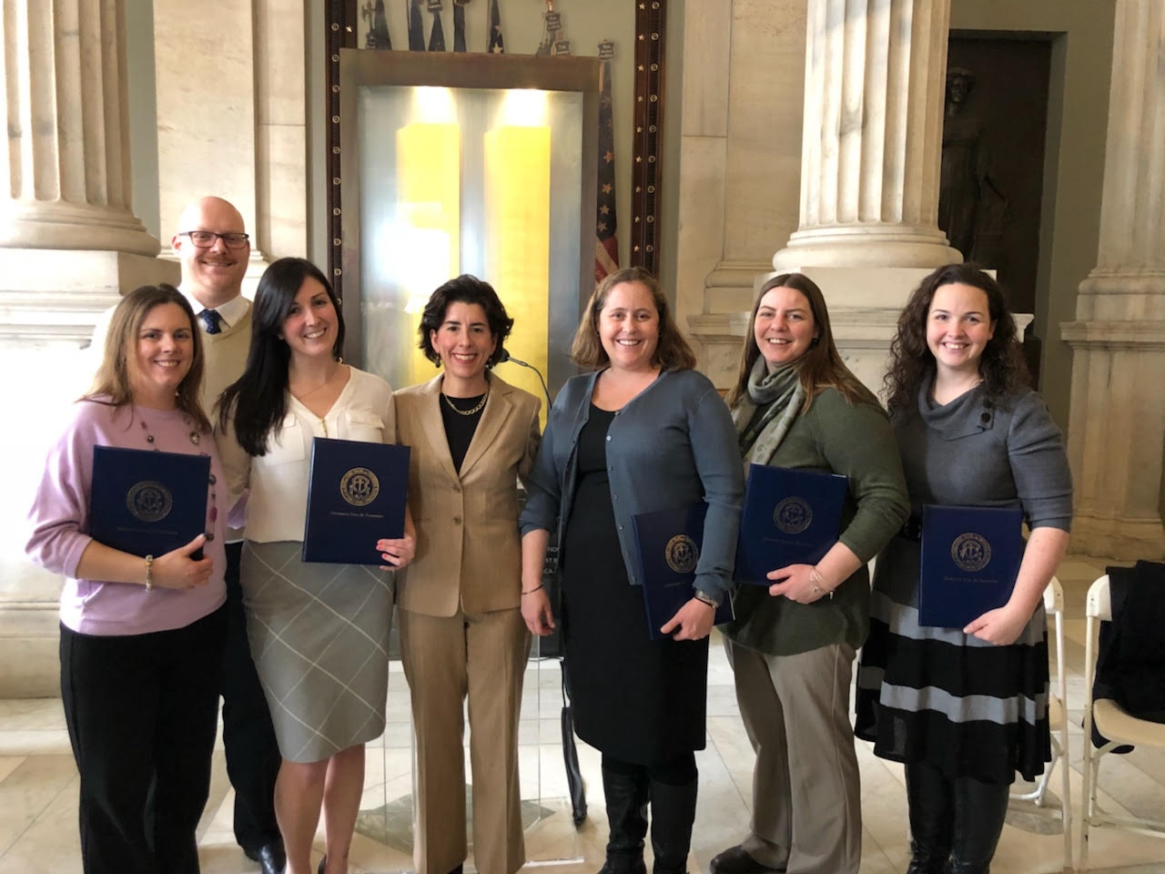 Foster America fellow Adam Williams and colleagues from the Rhode Island Department of Children, Youth, & Families receive the Rhody Service Award from Governor Gina Raimondo