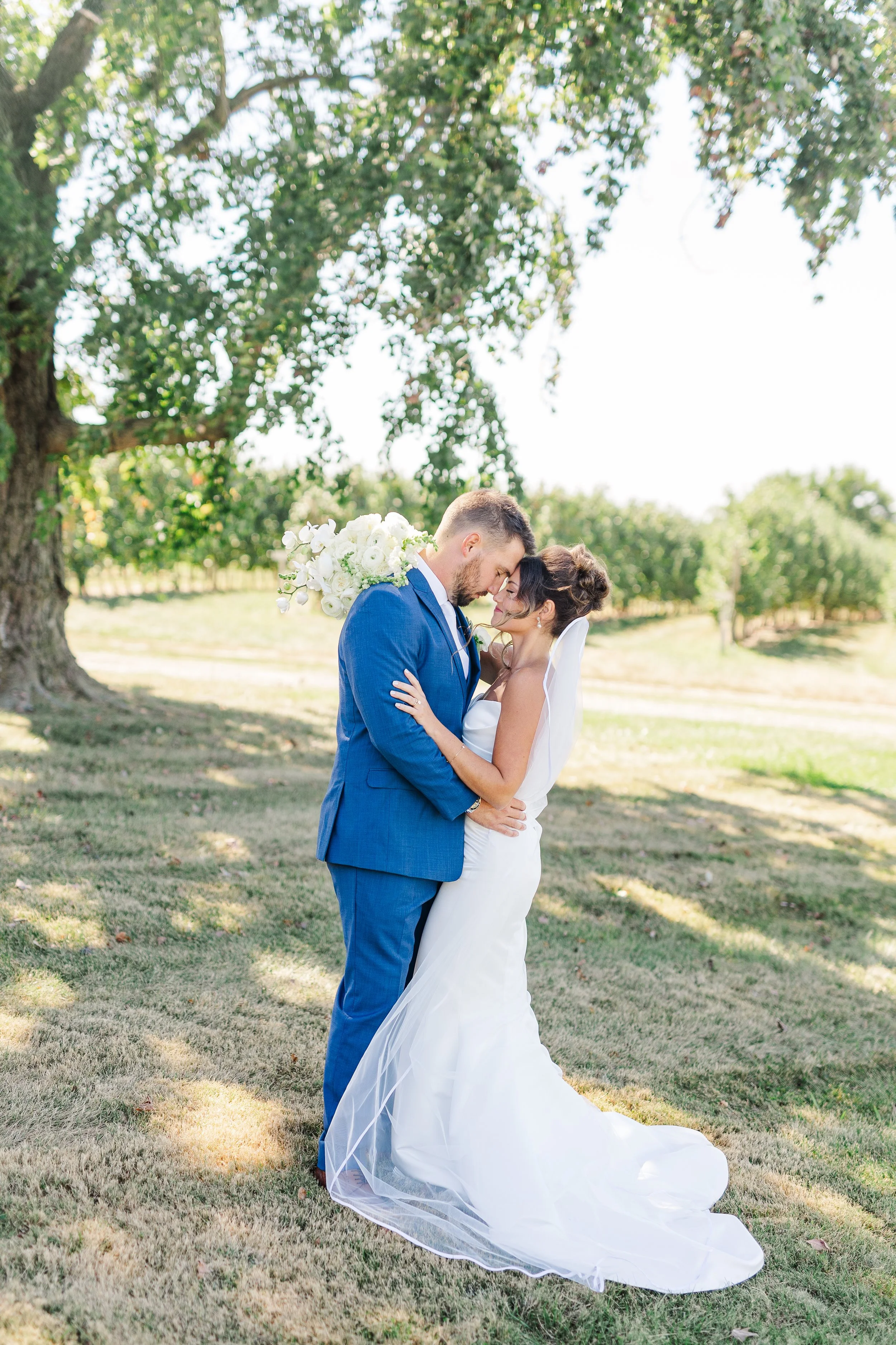 Bride and Groom posing on their wedding day at a farm.