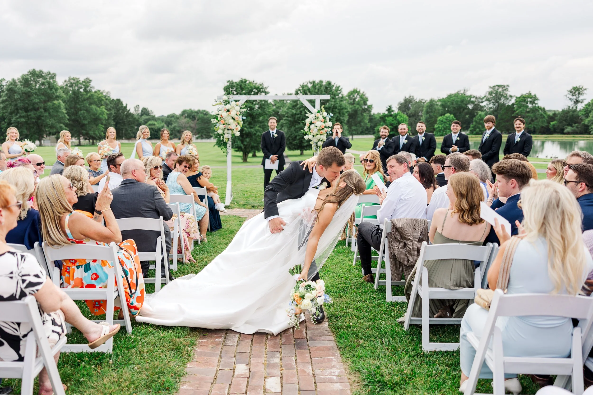 Elegant estate wedding ceremony dip kiss